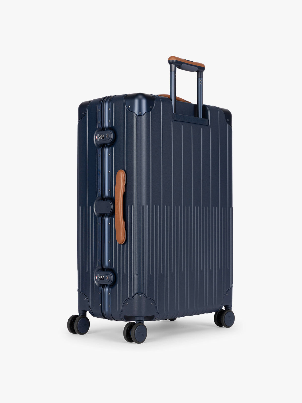 Backside of CALPAK Large Vault Luggage in blue Navy with hard-shell spinner suitcase with a ribbed vertical design, shown from the front on a light gray background; LVT1028-NAVY