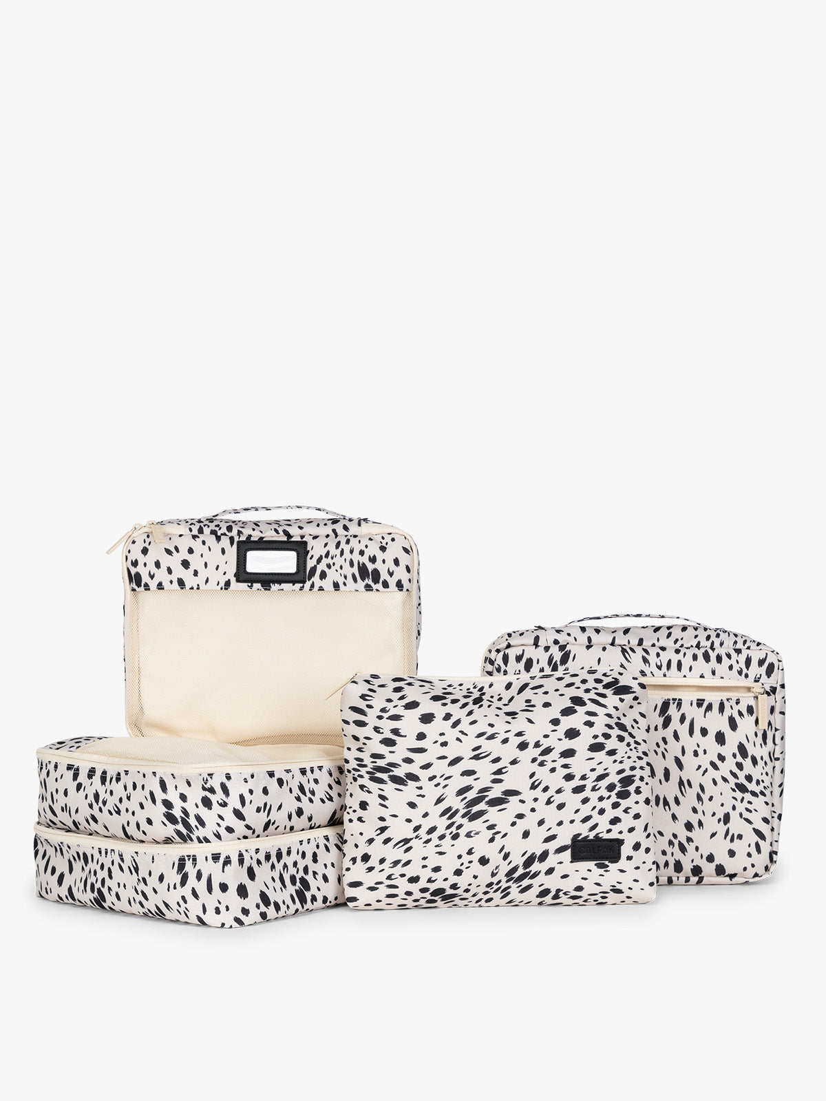 White and black animal pattern Snow Leopard CALPAK 5-piece travel packing cubes set which includes three mesh cubes, a flat cube, and a zippered organizer, displayed on a clean white background; PC1601-SNOW-LEOPARD
