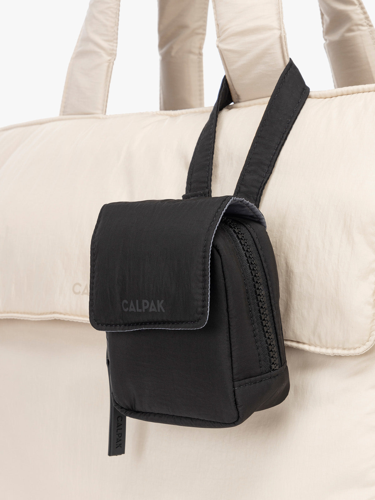 CALPAK Baby Collection Pacifier Pouch in Black clipped onto white bag; PCB2501-BLACK