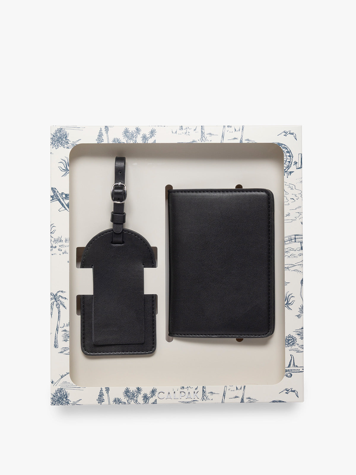 A black CALPAK Luggage Tag and Passport Holder Set presented in a white gift box with a blue decor, photographed against a clean white background; PWTS2601-BLACK