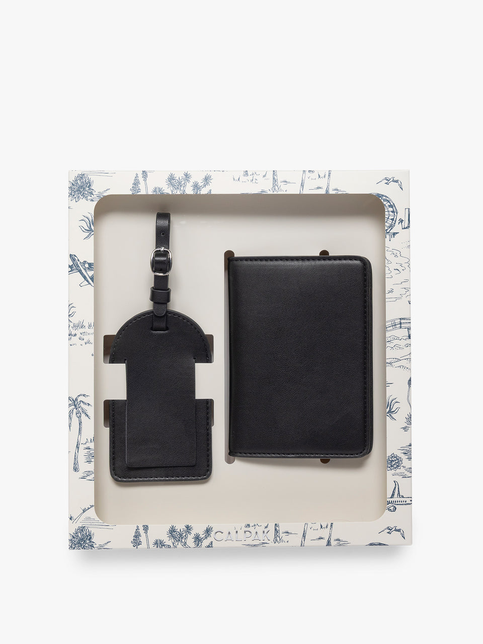 A black CALPAK Luggage Tag and Passport Holder Set presented in a white gift box with a blue decor, photographed against a clean white background; PWTS2601-BLACK