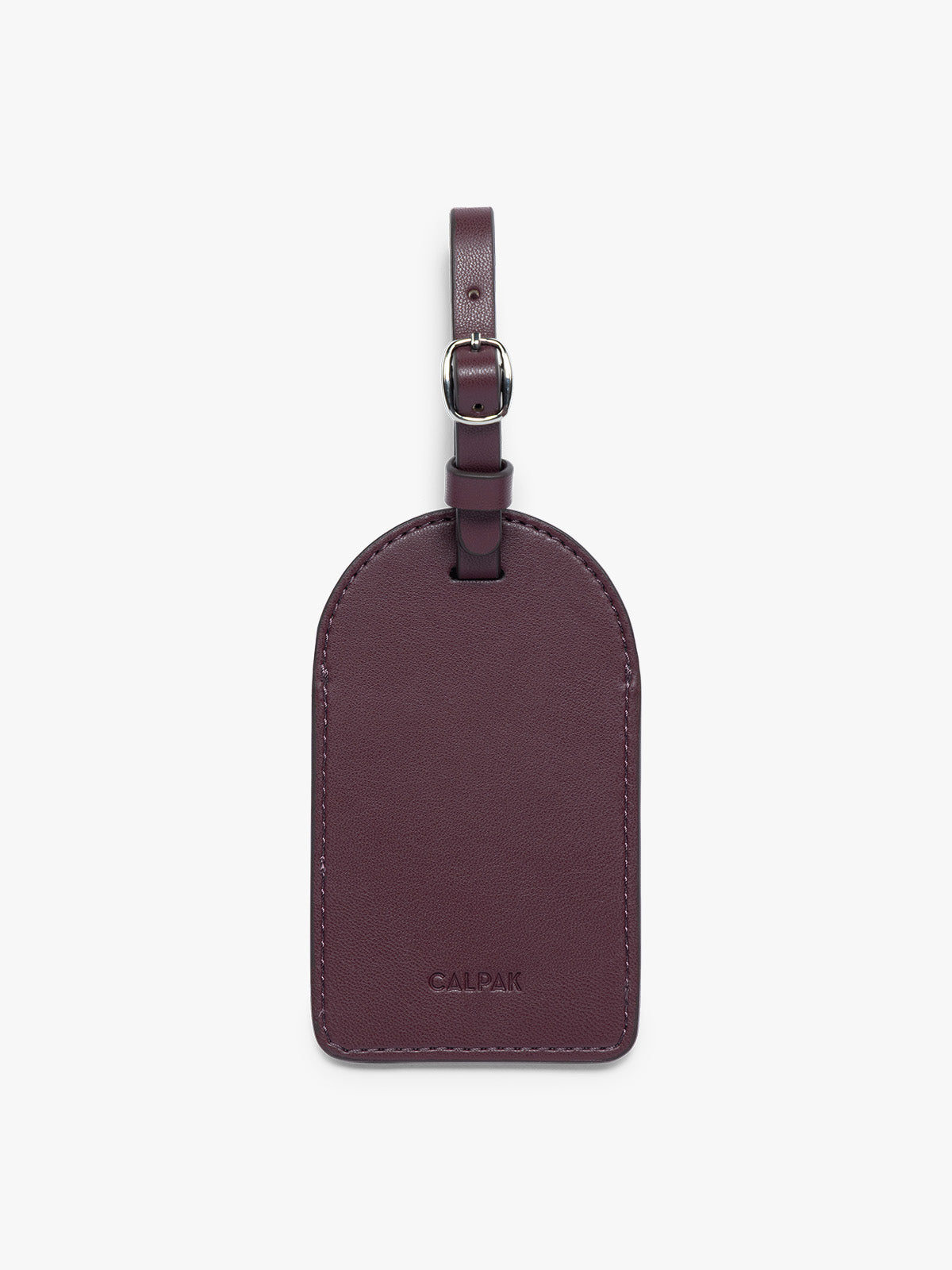 The back side view of dark burgundy CALPAK Luggage Tag with a matching strap and silver-tone metal buckle, featuring the embossed brand name 'CALPAK' at the bottom, shown on a clean white background; PWTS2601-DARK-CHERRY