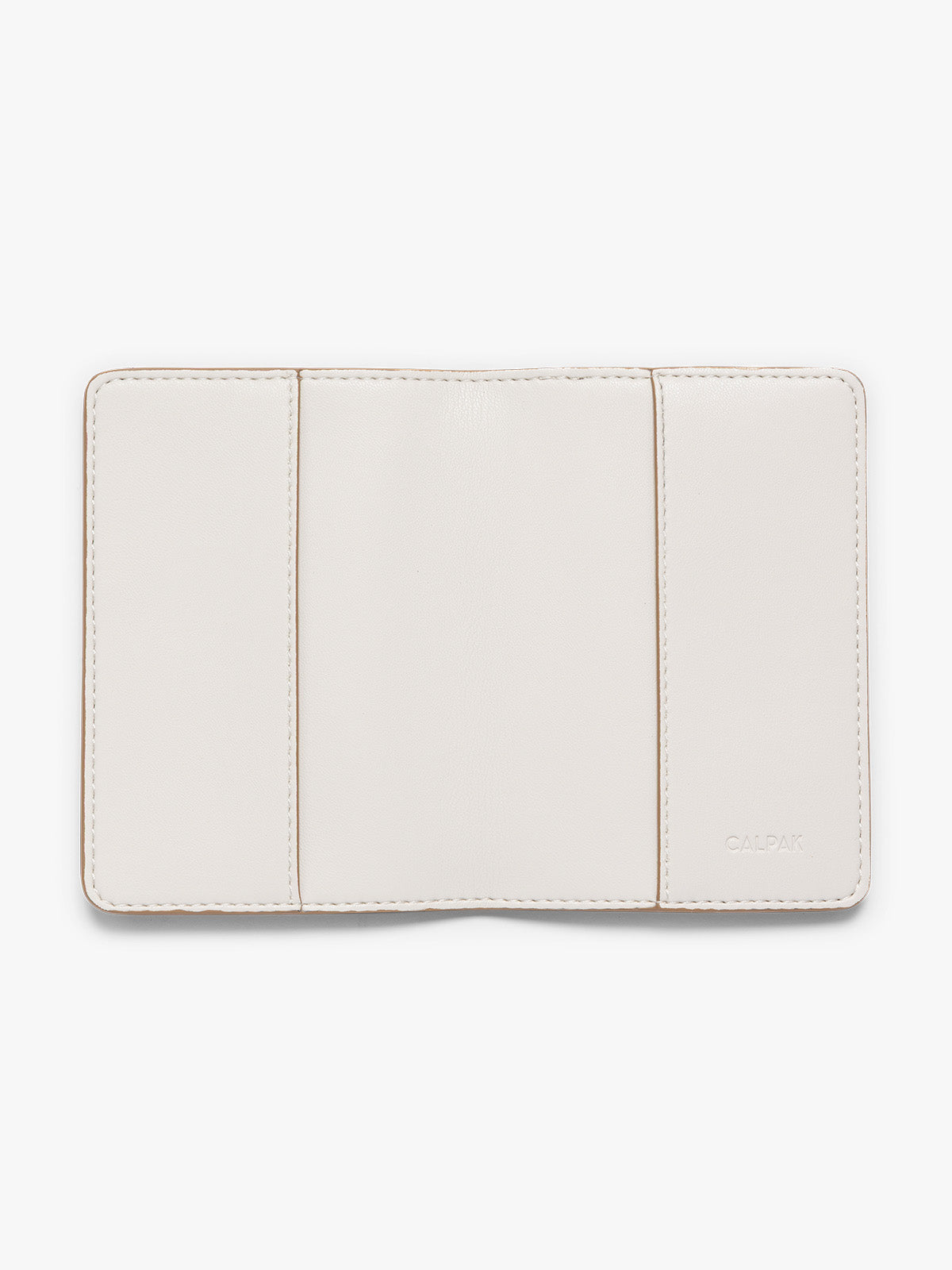 A cream CALPAK passport HOLDER shown open against a plain white background, featuring the brand name 'CALPAK' debossed on the bottom right PWTS2601-VANILLA