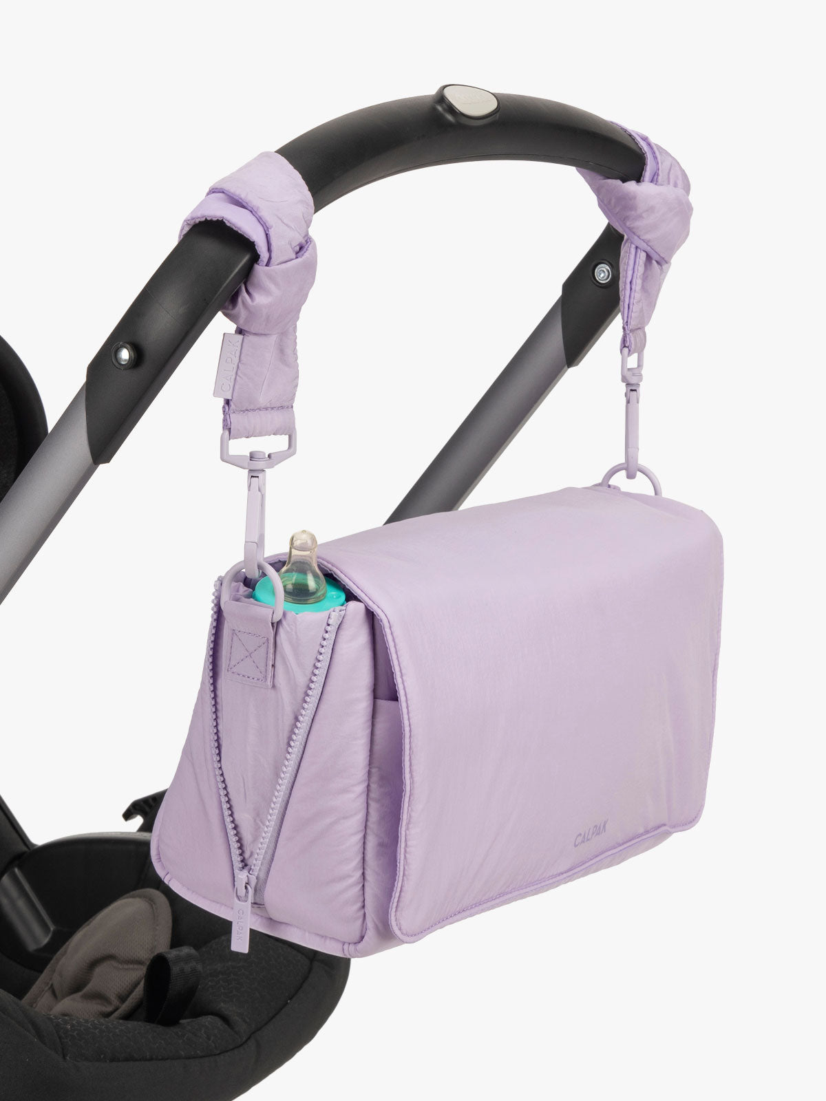 CALPAK Convertible Stroller Caddy Crossbody in lavender purple Orchid hanging on stroller with stroller straps; SCB2401-ORCHID