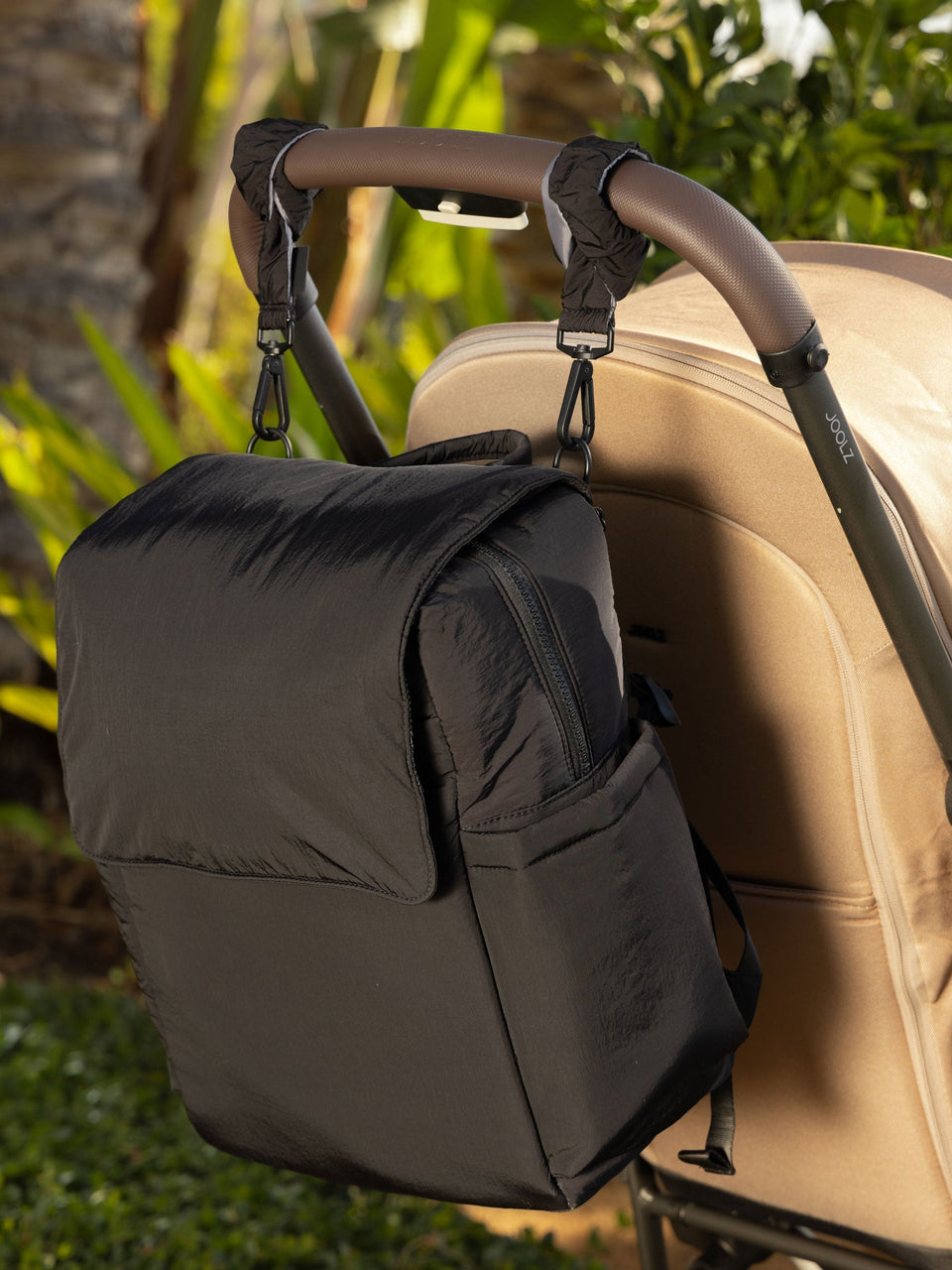 CALPAK Stroller Straps attached to Diaper Backpack with Laptop Sleeve in black; STP2401-BLACK