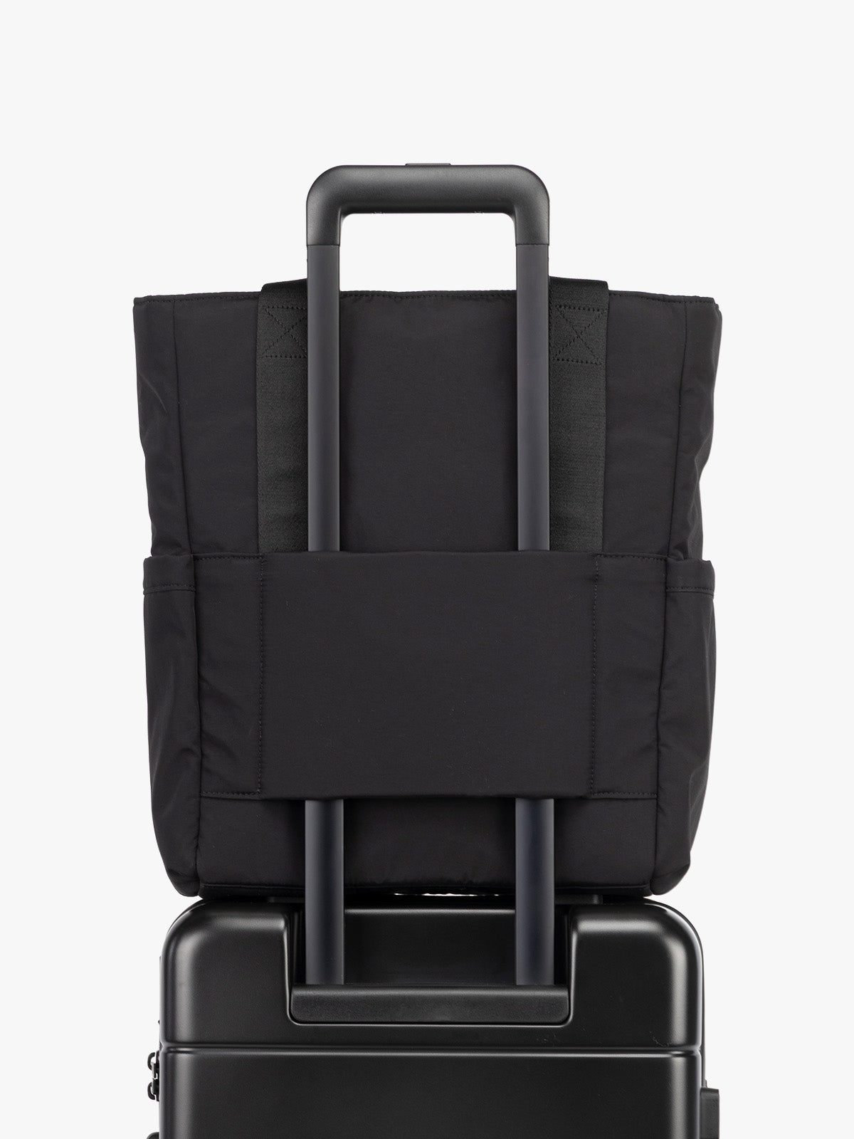 CALPAK Zippered Laptop Tote Bag in Black  on a white background with trolley sleeve; TCN2501-BLACK