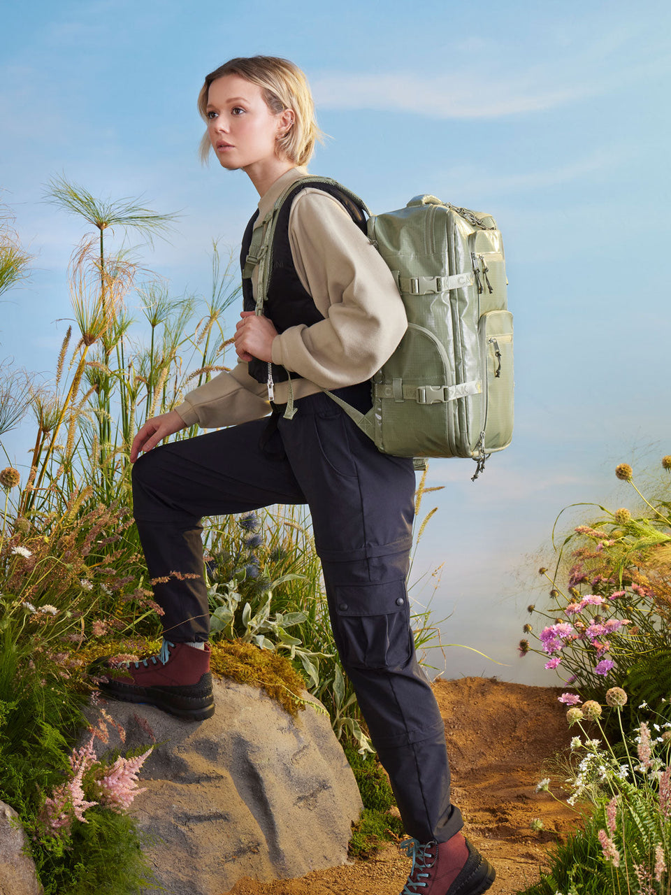 woman with CALPAK Terra 26l backpack duffel for camping; BPH2201-JUNIPER