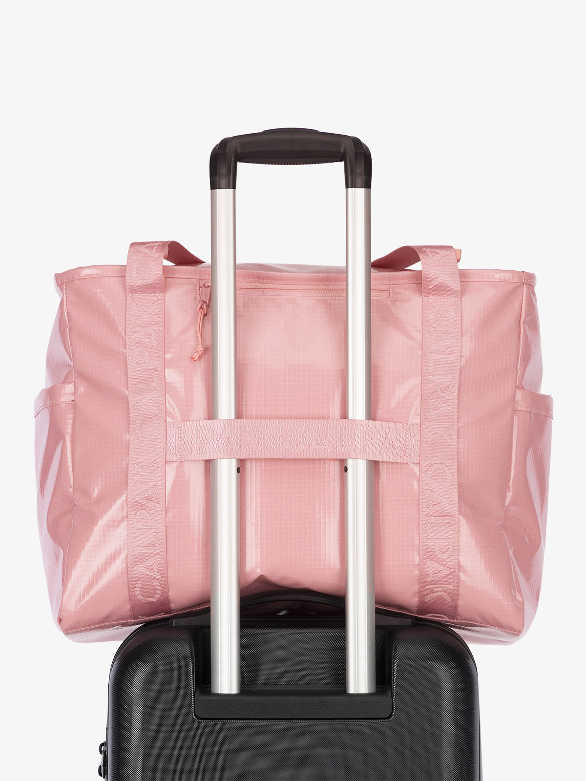 Luggage trolley sleeve of CALPAK Terra 35L Water Resistant Zippered Tote Bag in pink; TTO2401-BLOSSOM