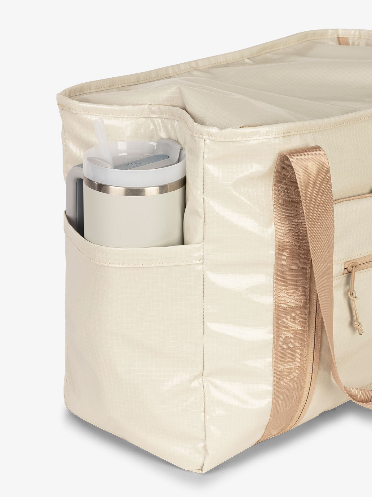 CALPAK Terra 35L Water Resistant Zippered Tote Bag with exterior side pocket that can fit large water bottle in white sands beige; TTO2401-WHITE-SANDS