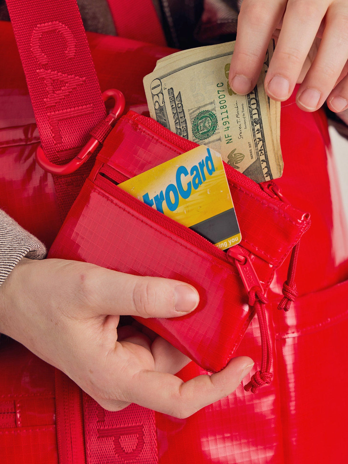 CALPAK Terra Clippable Card pouch in Red being used for card and cash wallet; TPC2401-FLAME