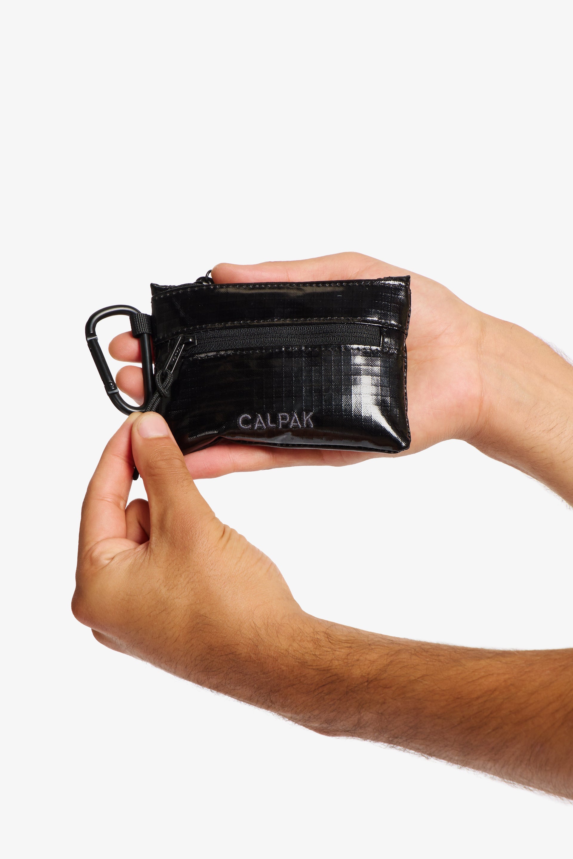Model holding CALPAK Terra Clippable Card Pouch in Black; TPC2401-OBSIDIAN