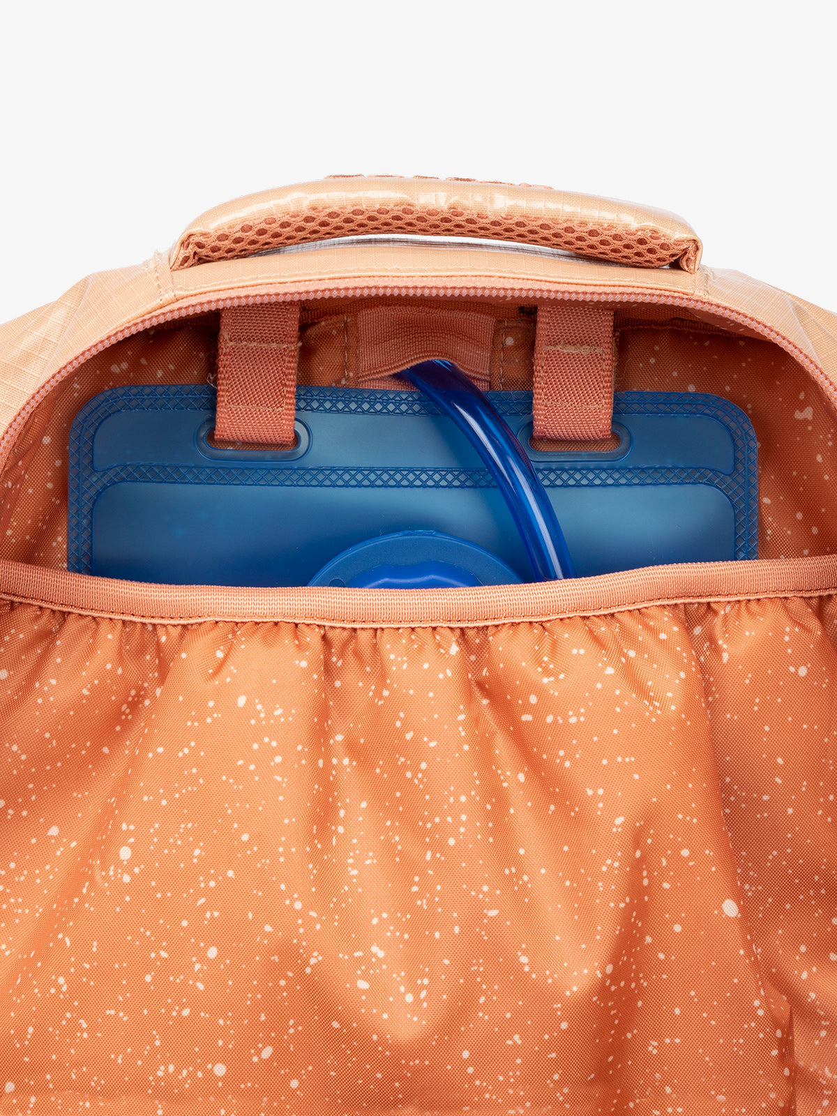 Close up of CALPAK 2L removable hydration reservoir back-slip pocket in orange; BPT2201-CANYON