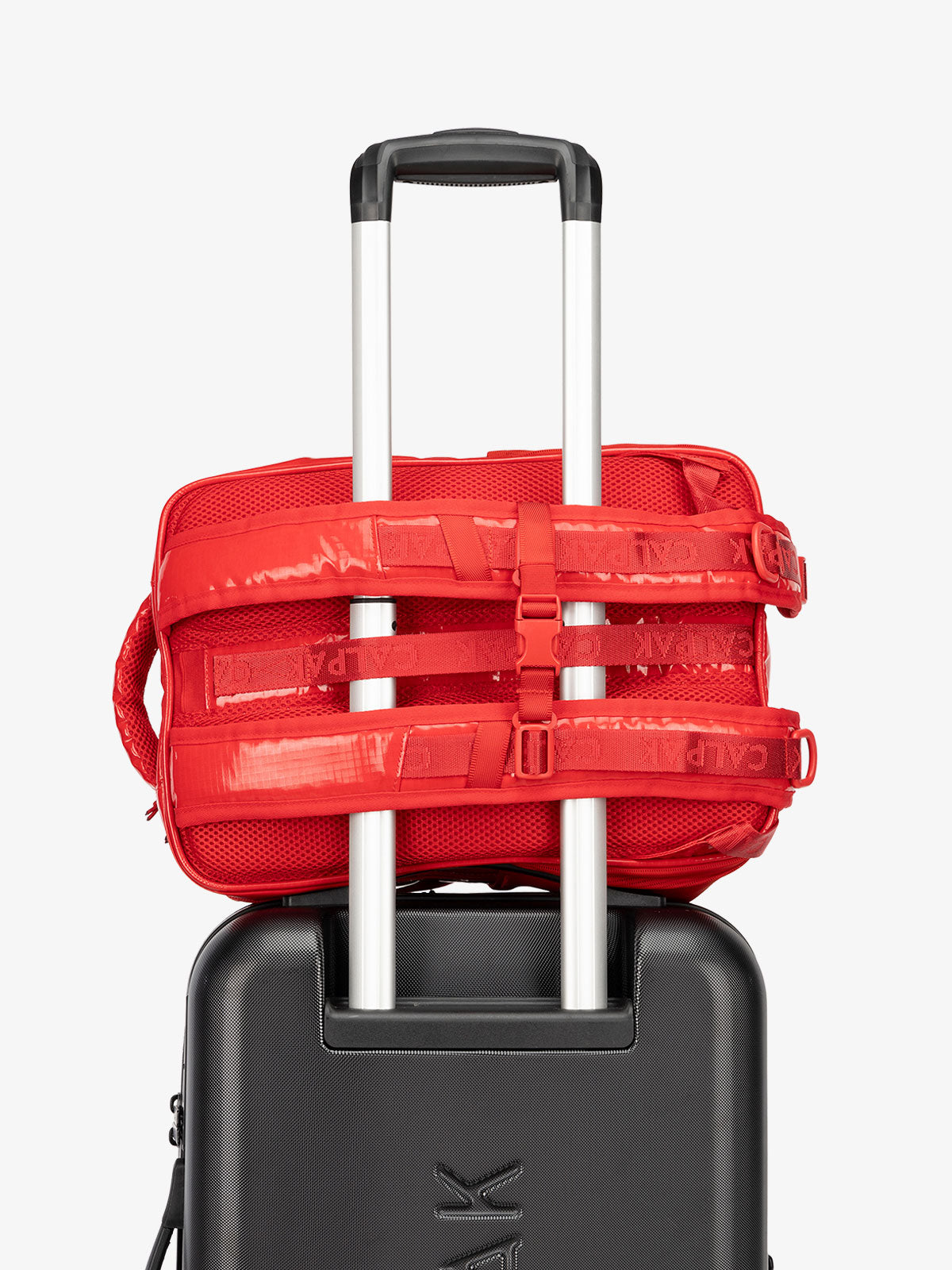 CALPAK hydration backpack with luggage trolley strap and and adjustable shoulder straps in red flame; BPT2201-FLAME
