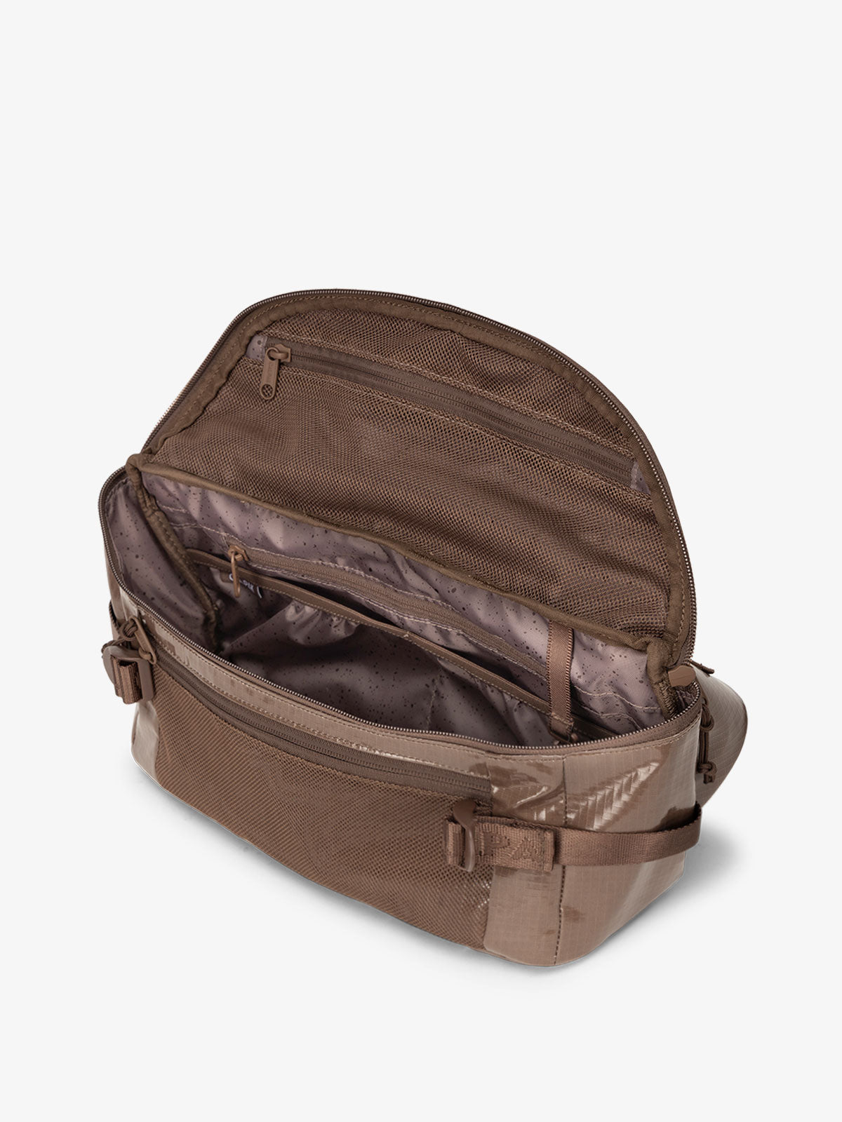 CALPAK Terra Sling Crossbody Bag for hiking with multiple pockets and adjustable straps in brown; CBH2201-CACAO