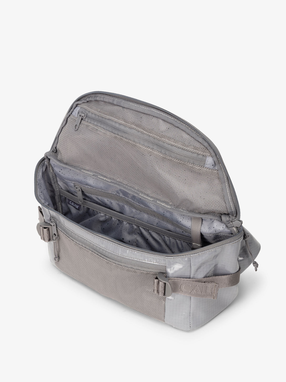 CALPAK Terra Sling Crossbody Bag for hiking with multiple pockets and adjustable straps in storm; CBH2201-STORM