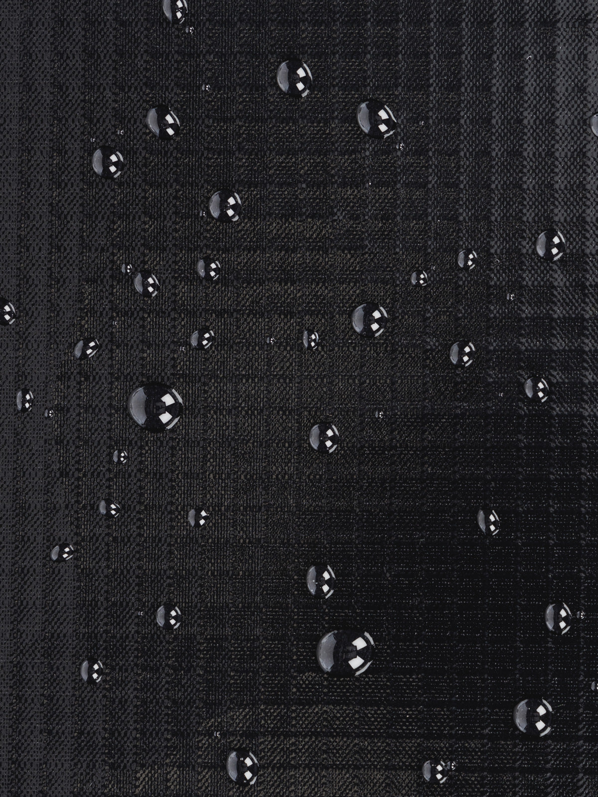 Water resistant material shown with water droplets on CALPAK Terra Zippered Passport Wallet in black Obsidian; ATPW2501-OBSIDIAN