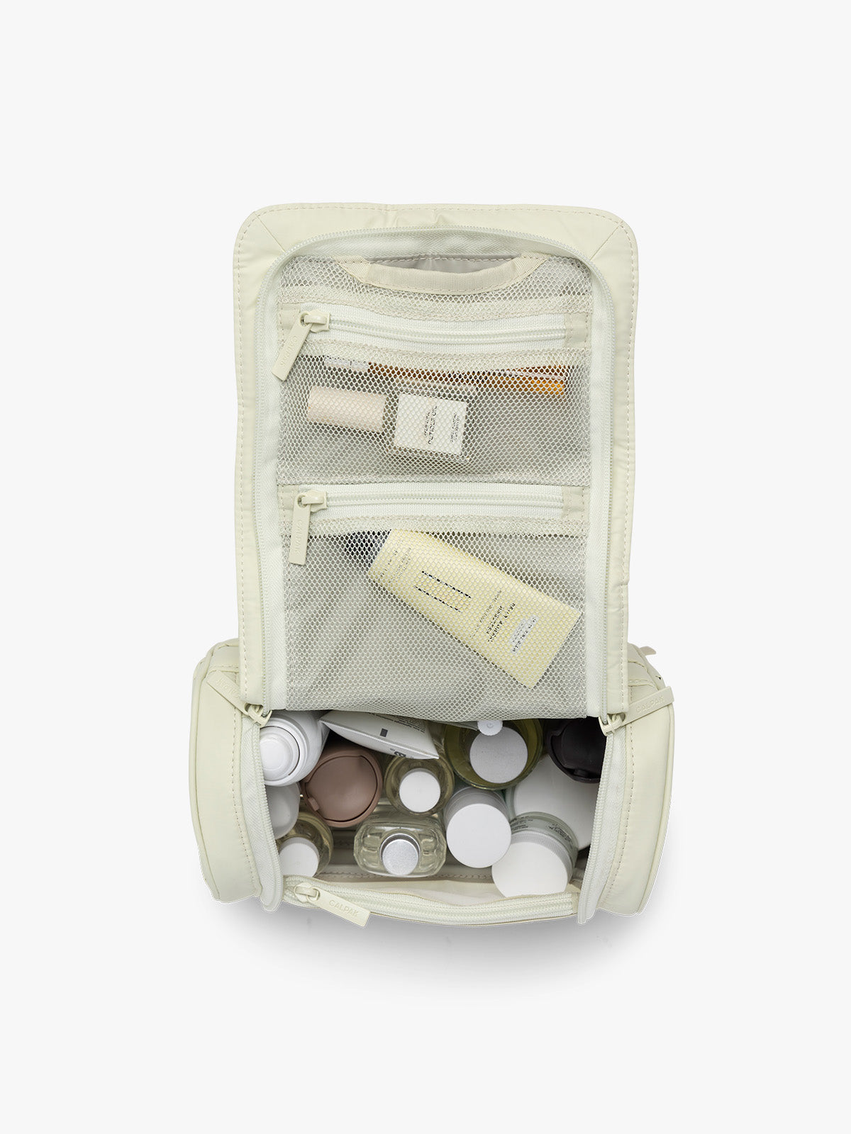 Toiletries in CALPAK Luka Hanging Toiletry Bag in light green Celadon; TLH2301-CELADON