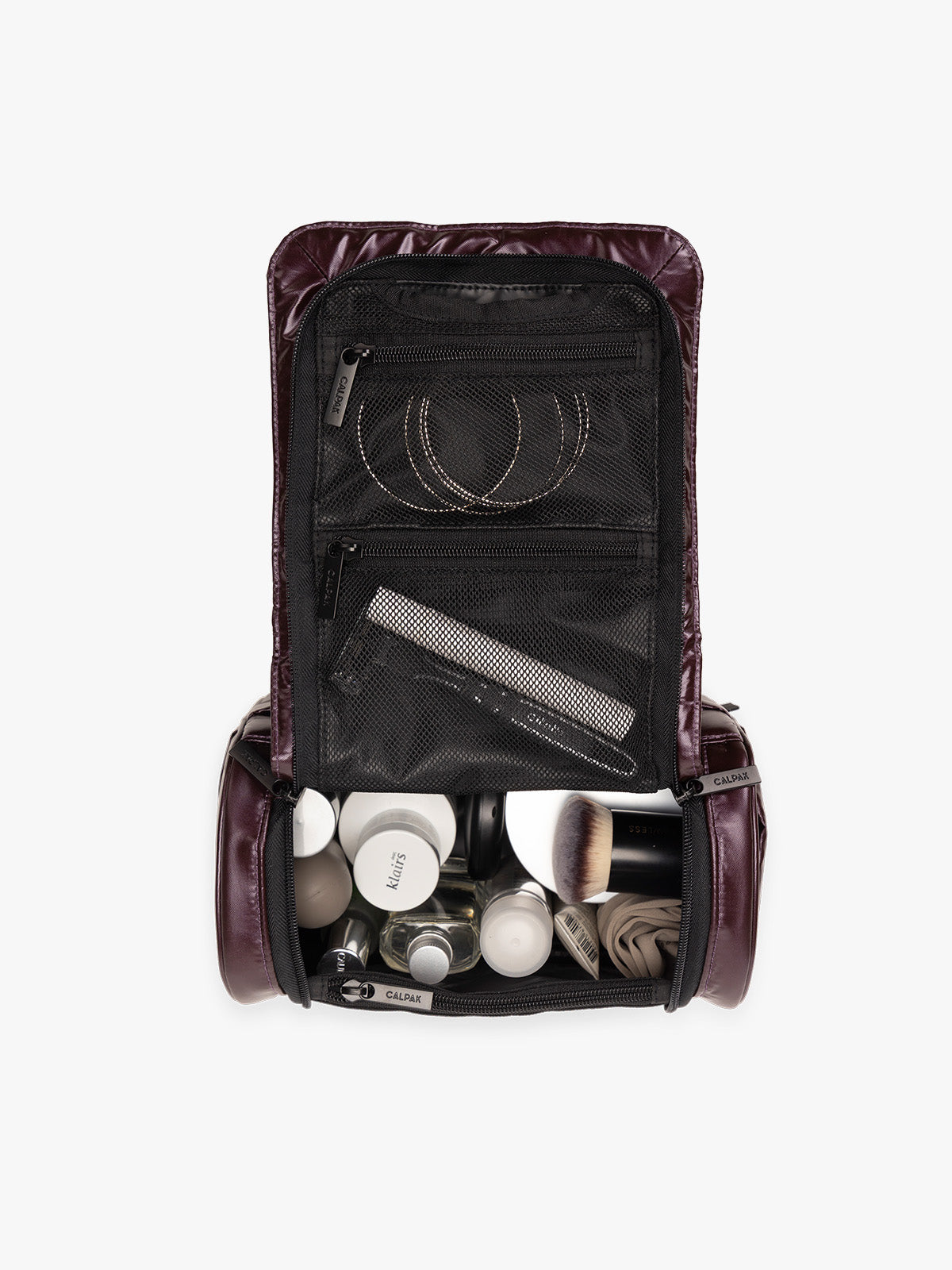 Items in the CALPAK Luka Hanging Toiletry Bag in maroon Glazed Dark Cherry; TLH2301-GLAZED-DARK-CHERRY