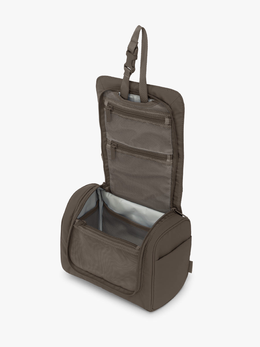 Opened CALPAK Luka Hanging Toiletry Bag in brown Mushroom; TLH2301-MUSHROOM