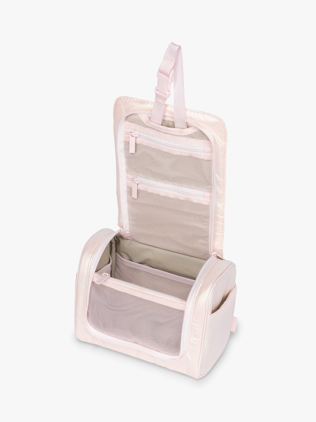 Opened CALPAK Luka Hanging Toiletry Bag in light pink shiny Pearlescent; TLH2301-PEARLESCENT