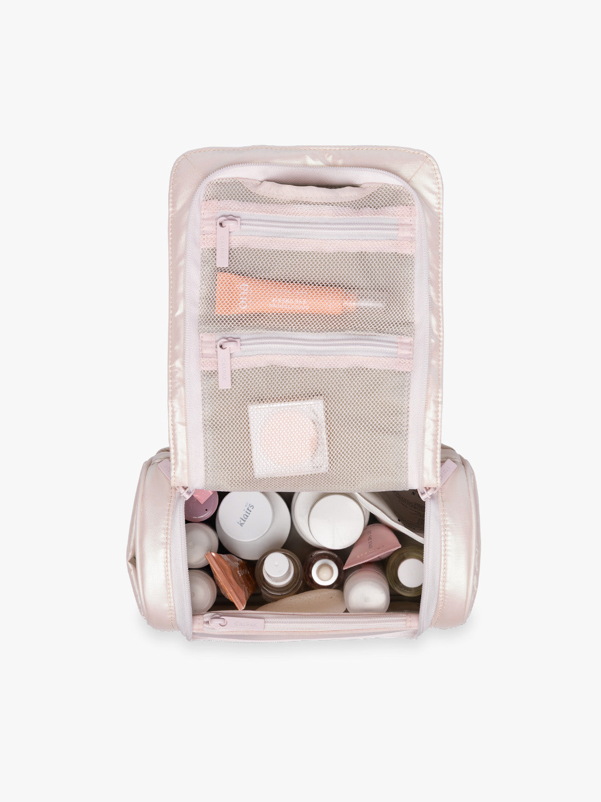 Items in CALPAK Luka Hanging Toiletry Bag in light pink shiny Pearlescent; TLH2301-PEARLESCENT