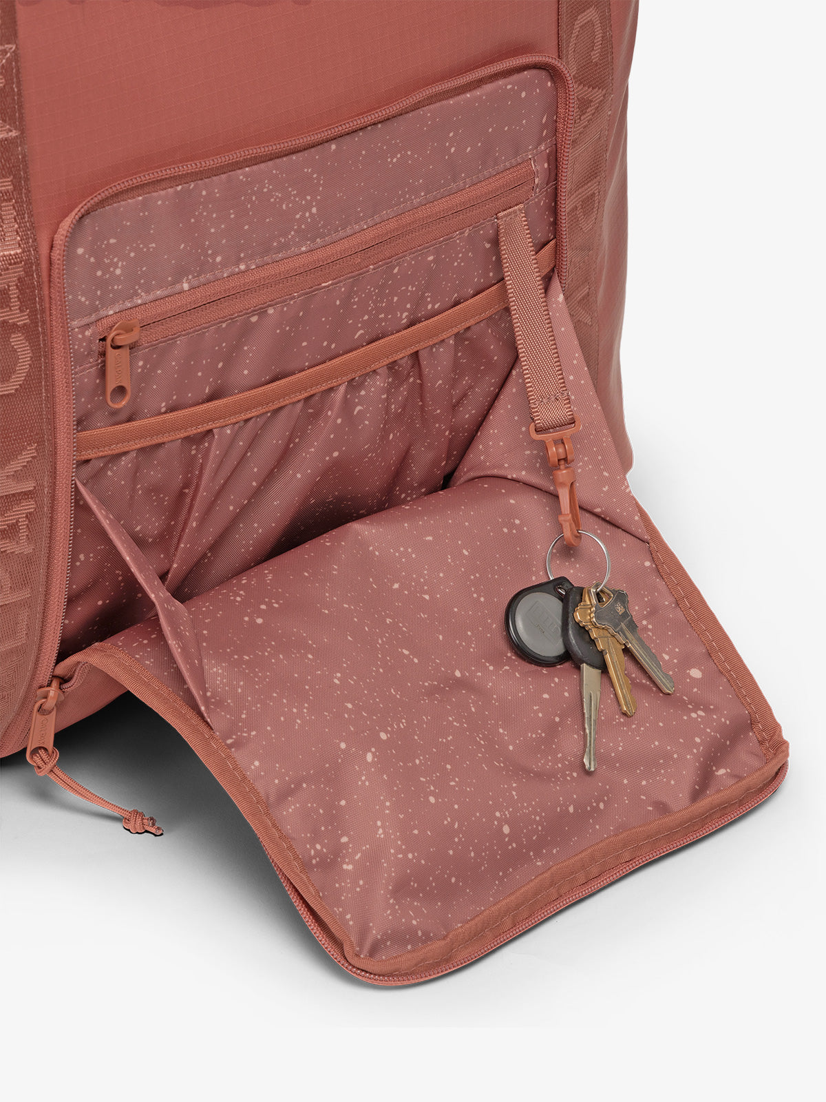 CALPAK Terra 35L Water Resistant Zippered Tote Bag in red and orange Matte Clay front pocket detail; TTO2401-CLAY