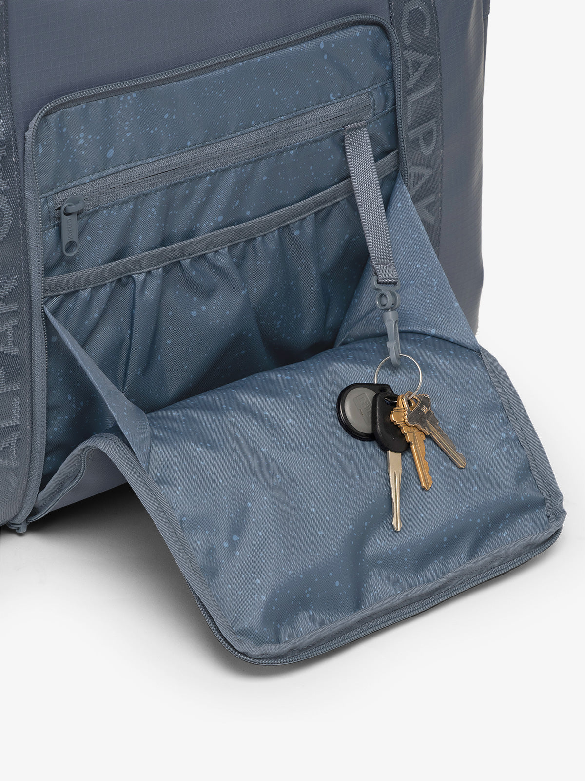 CALPAK Terra 35L Water Resistant Zippered Tote Bag in blue Matte Indigo front pocket detail; TTO2401-INDIGO