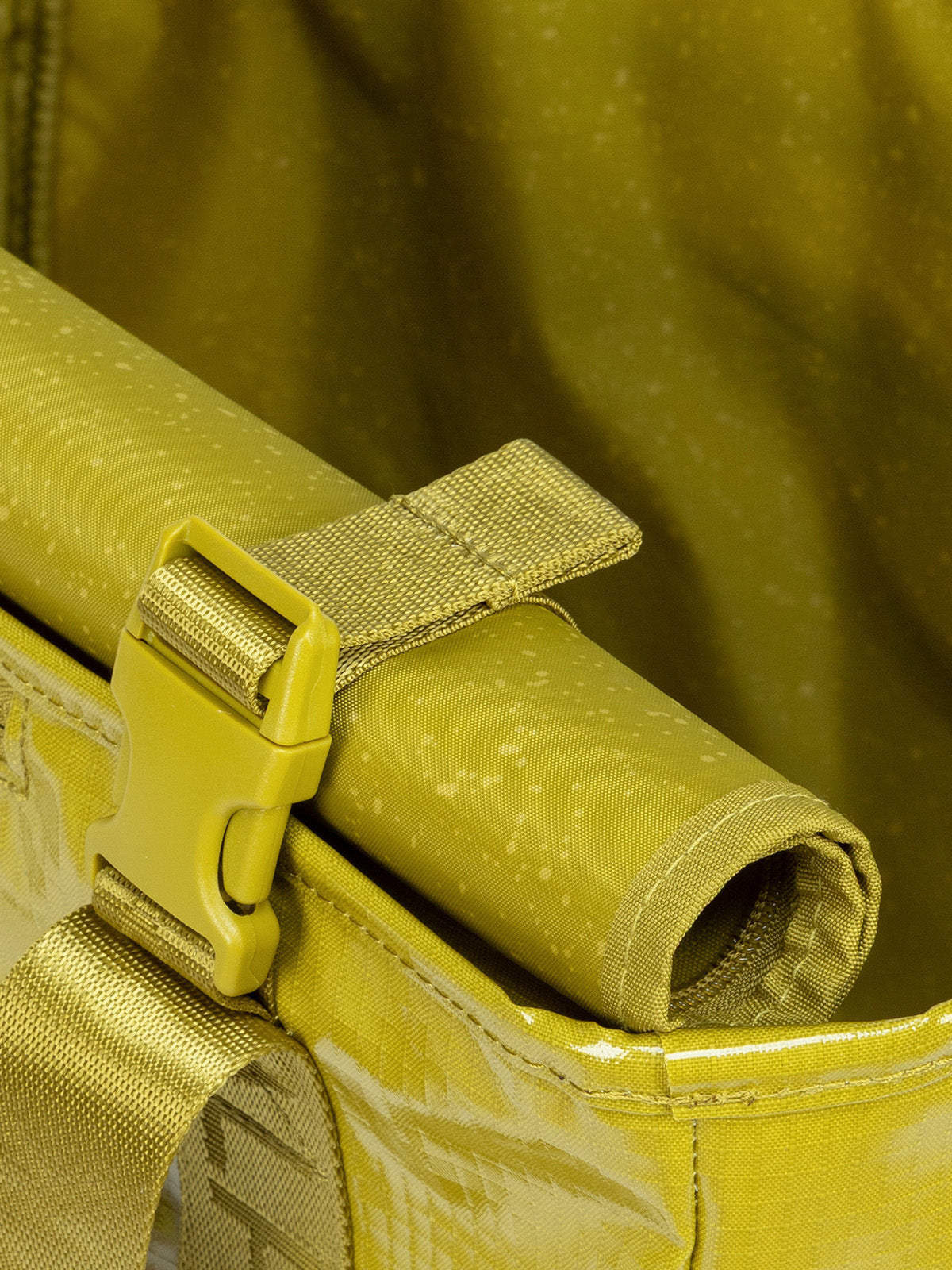 Rollable top of CALPAK Terra 35L Tote Bag with zippers in yellow green Wasabi on a white background; TTO2401-WASABI