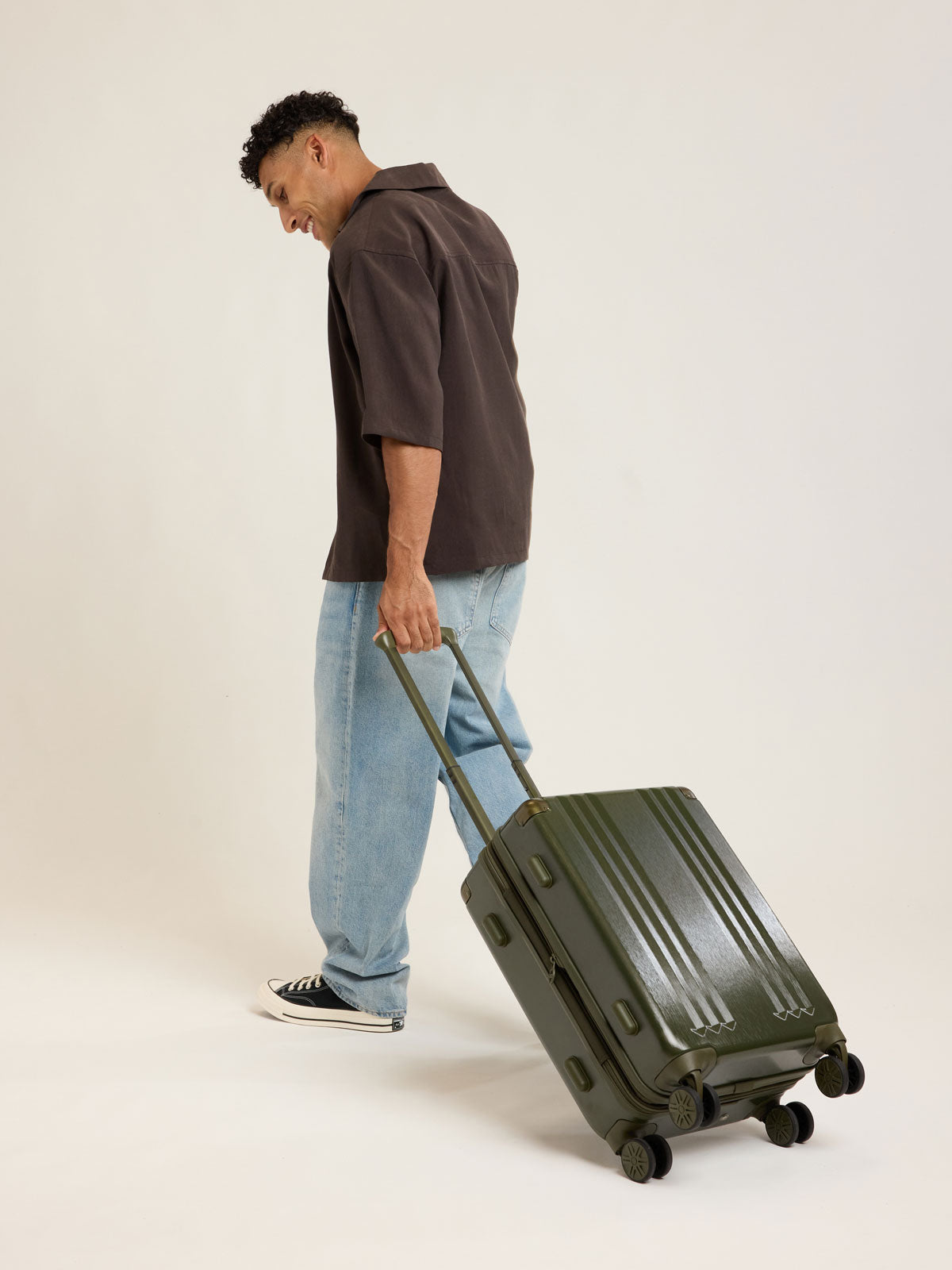 Model with CALPAK Ambeur Carry On Luggage in dark green Pine; LAM1020-PINE