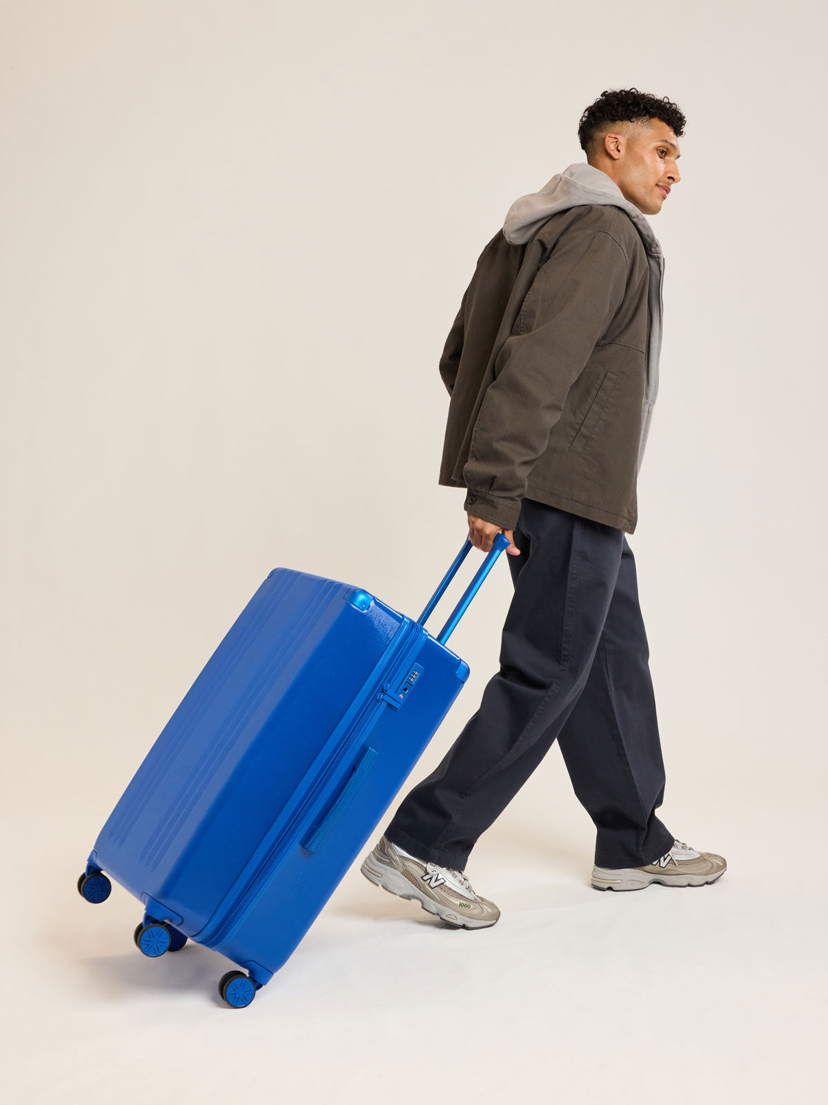 Model with CALPAK Ambeur Large Luggage in dark blue Cobalt; LAM1028-COBALT