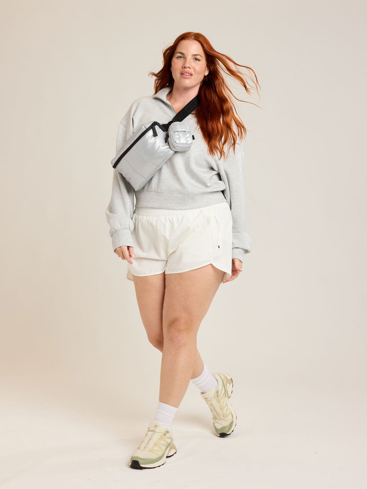 Model wearing the CALPAK Luka Belt Bag in Silver; BB1901-SILVER