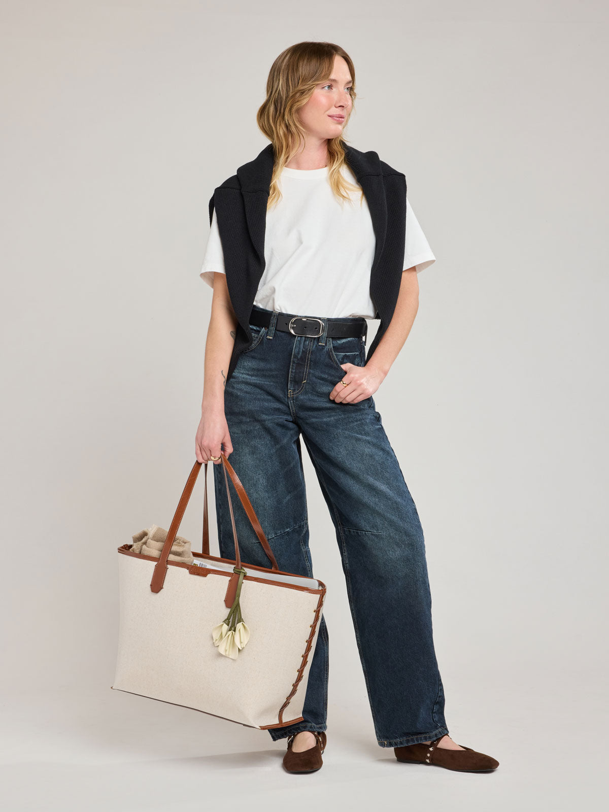 Model with CALPAK Colette 15" Canvas Laptop Tote in beige canvas material  with brown finishing in Natural Brown; CLCT2601-NATURAL-BROWN