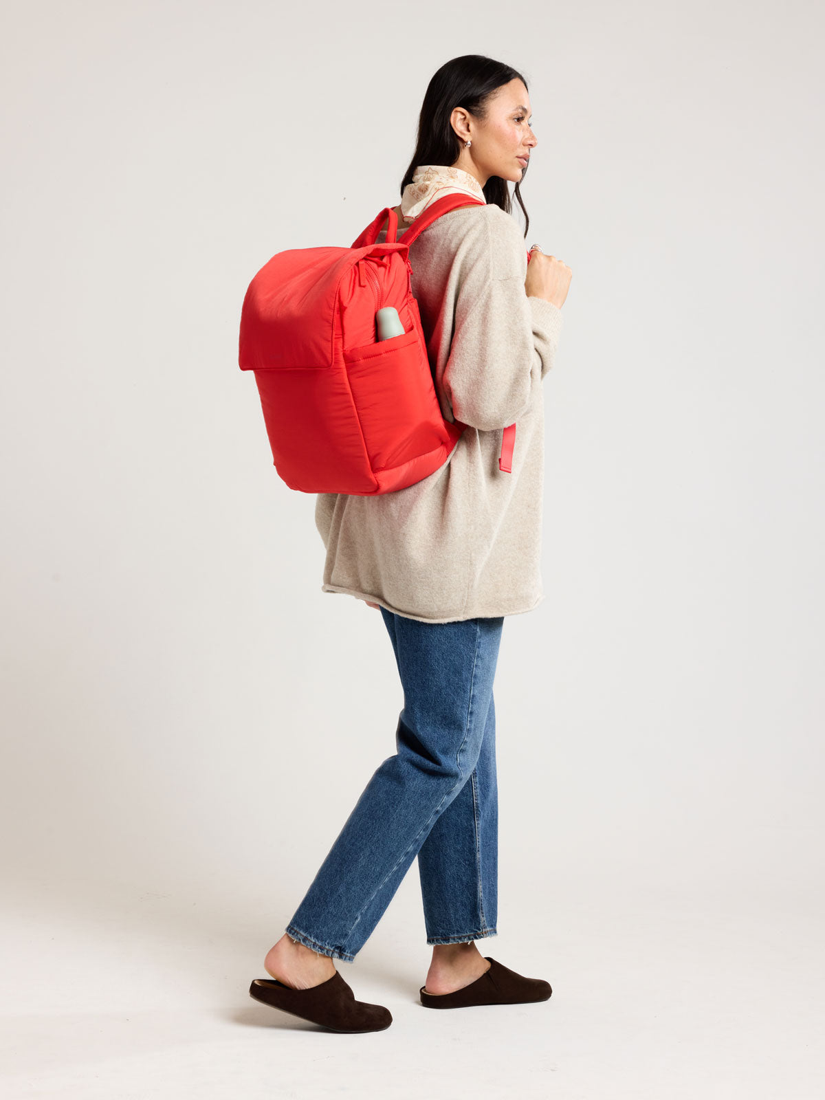Woman wearing CALPAK Diaper Backpack in red Tomato; BPB2401-TOMATO