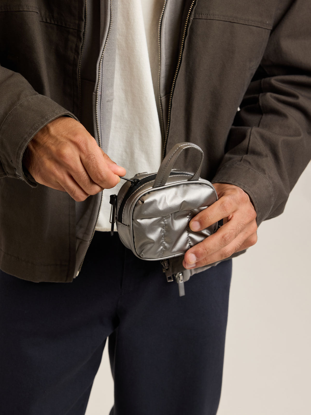Model with CALPAK Luka Duffel Zip Bag Charm in dark silver Gunmetal; ALK2501-GUNMETAL