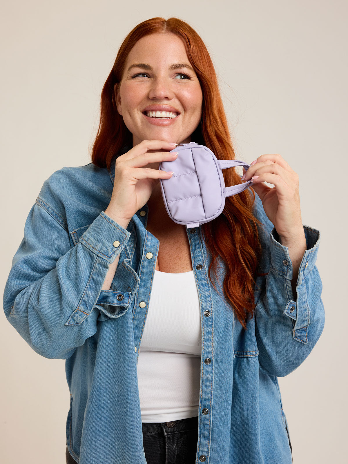 Model with CALPAK Luka Duffel Zip Bag Charm in lavender Orchid; ALK2501-ORCHID