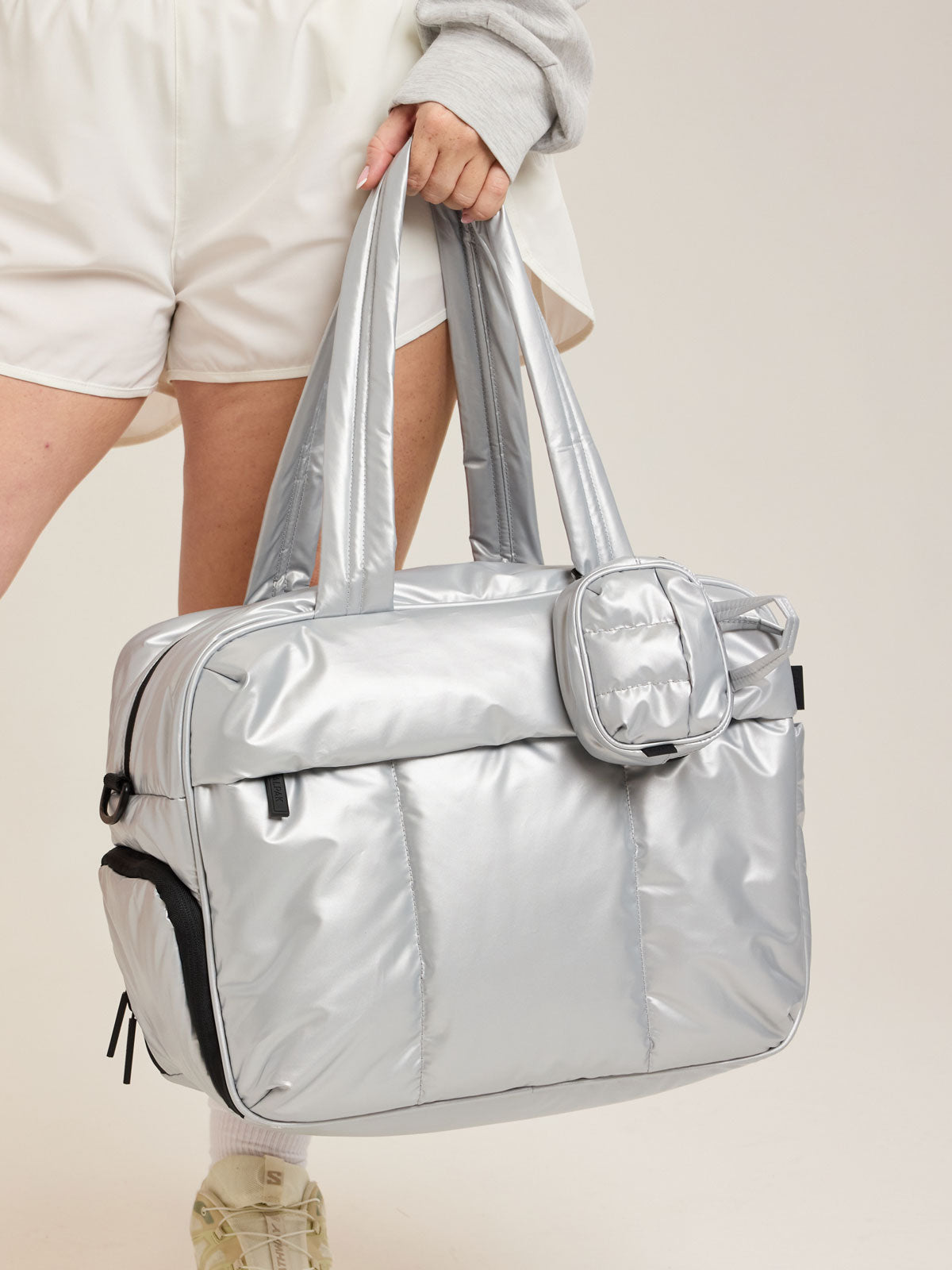 CALPAK Luka Duffel Key Pouch in Silver attached to the CALPAK Luka Duffel in Silver; ALK2501-SILVER