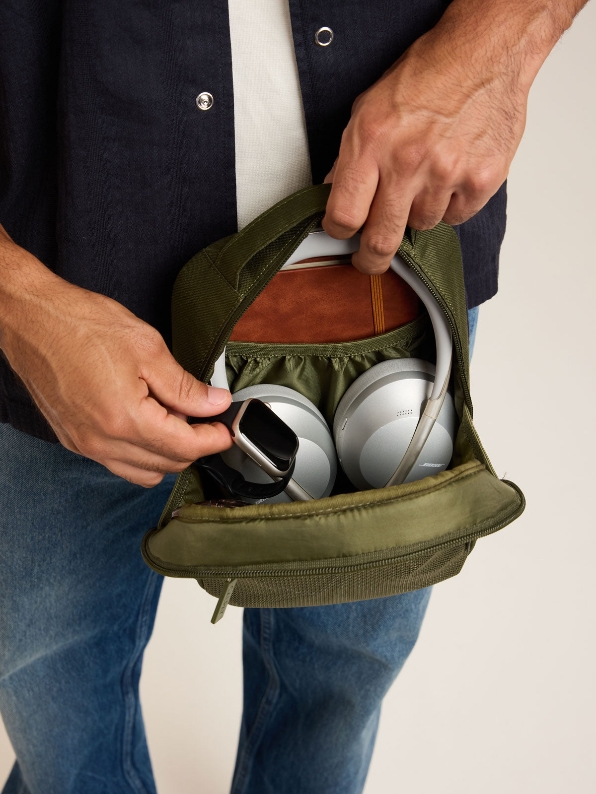 Model holding CALPAK Everything Cube in dark green MOSS; ACE2401-MOSS