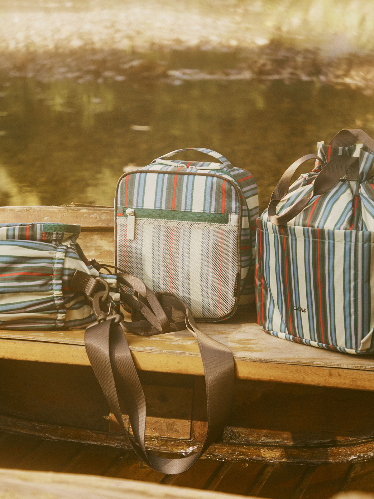 CALPAK Everything Cube in multicolor stripe on a bench ; ACE2401-RIVIERA-STRIPE