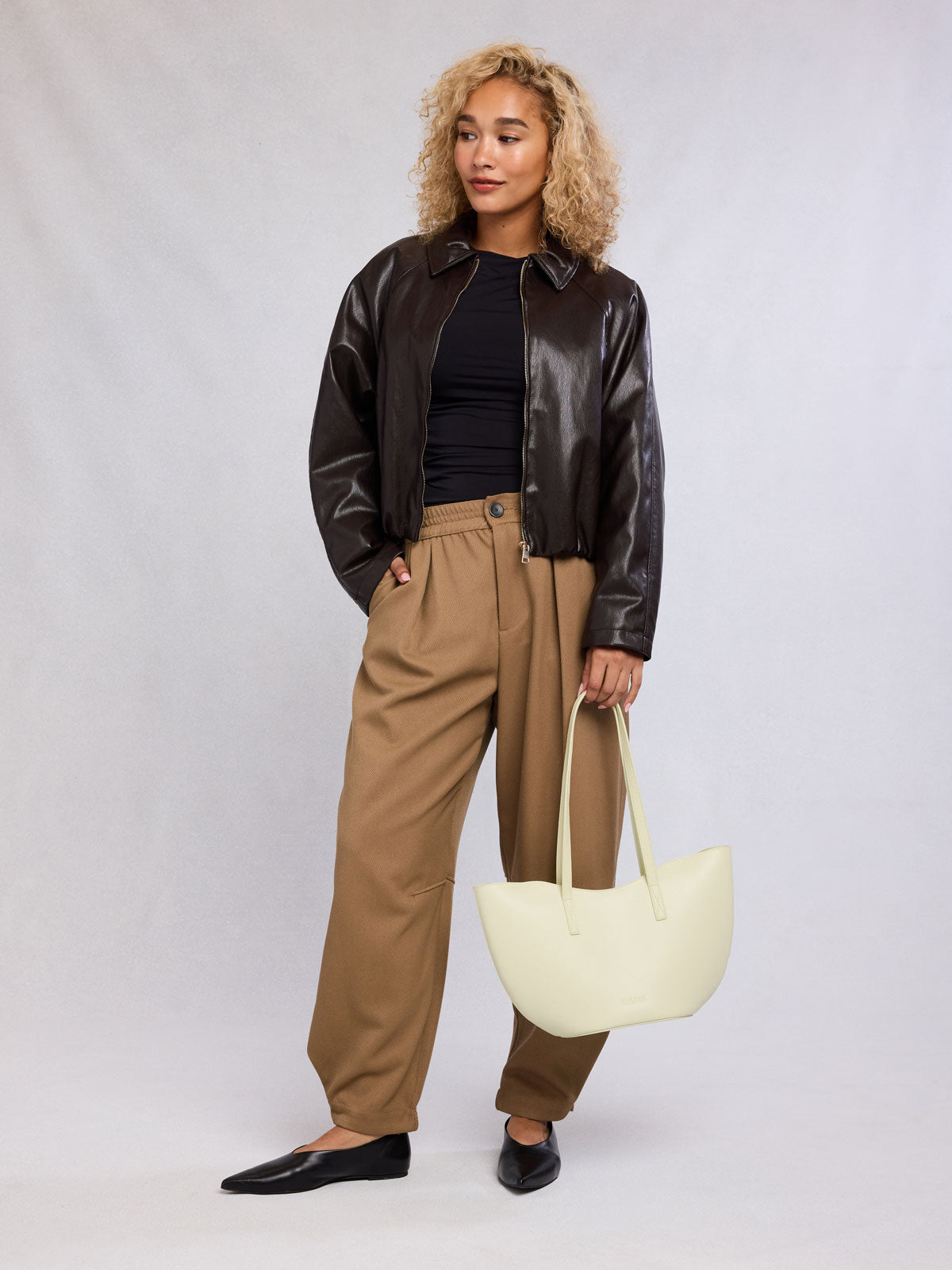 Woman with CALPAK Haven Tulip Tote in beige Buttercream; AHP2601-BUTTERCREAM
