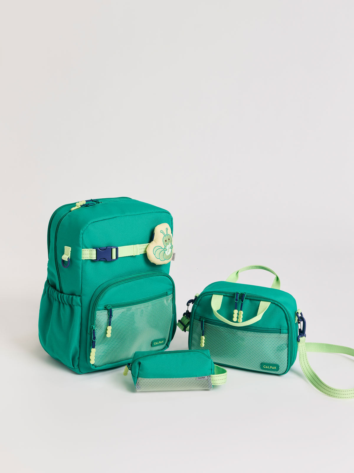Green CALPAK Kids Small Essentials Bundle that includes backpack and lunch bag, and pencil case light gray background; BCKL5000-GREEN