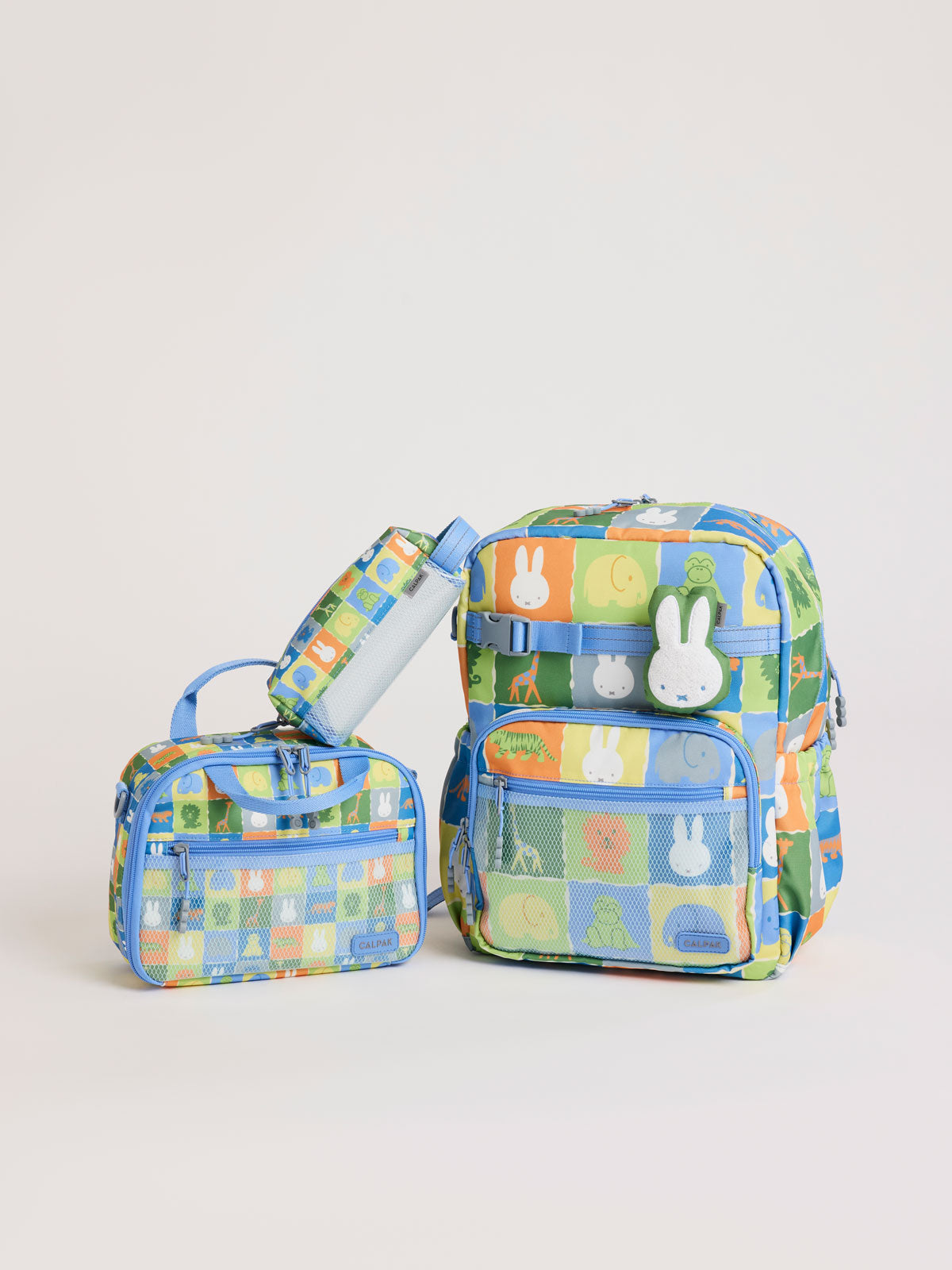 Colorful CALPAK + Miffy Kids Essentials Set with children's Large backpack, lunch bag , pencil case set on a white background with blue accents and Miffy with other animals; BCKL5000-MIFFY-BLUE-ZOO-TRIP