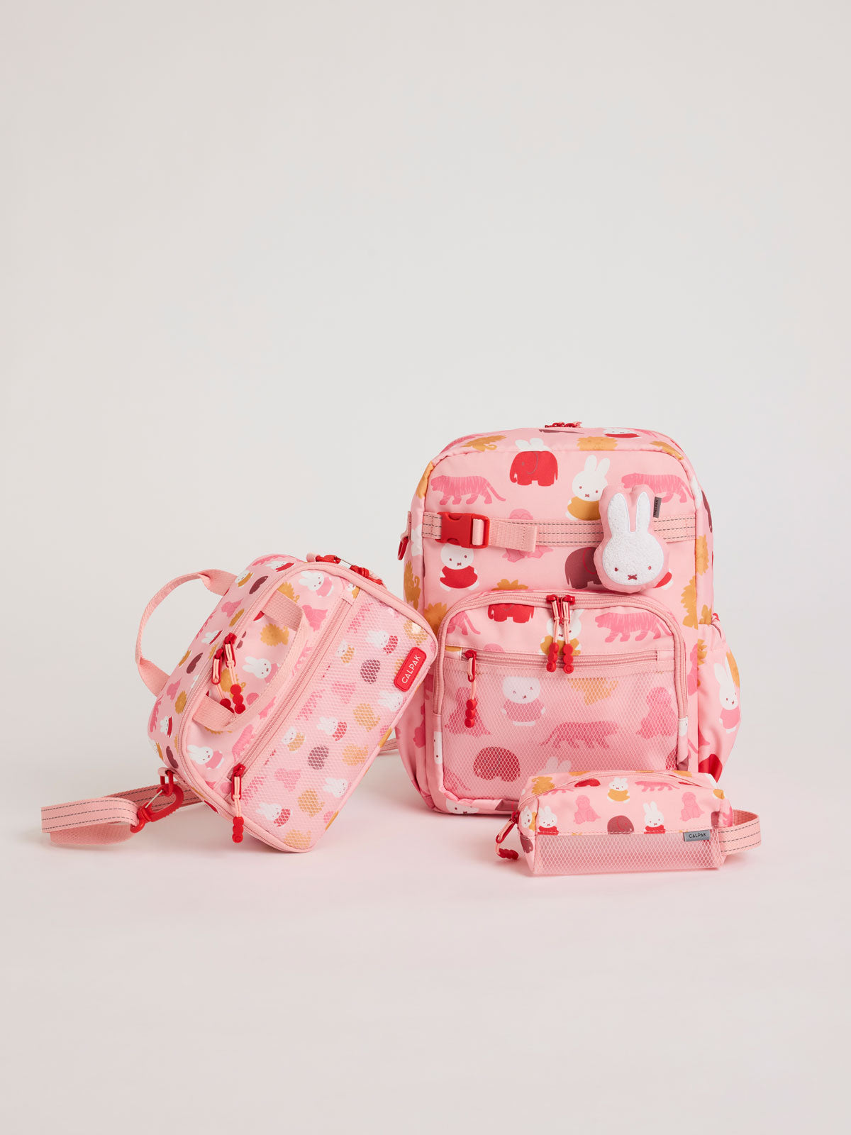 Colorful CALPAK + Miffy Kids Essentials Set with children's Large backpack, lunch bag , pencil case set on a white background with pink accents and Miffy with other animals; BCKL5000-MIFFY-PINK-ZOO-TRIP
