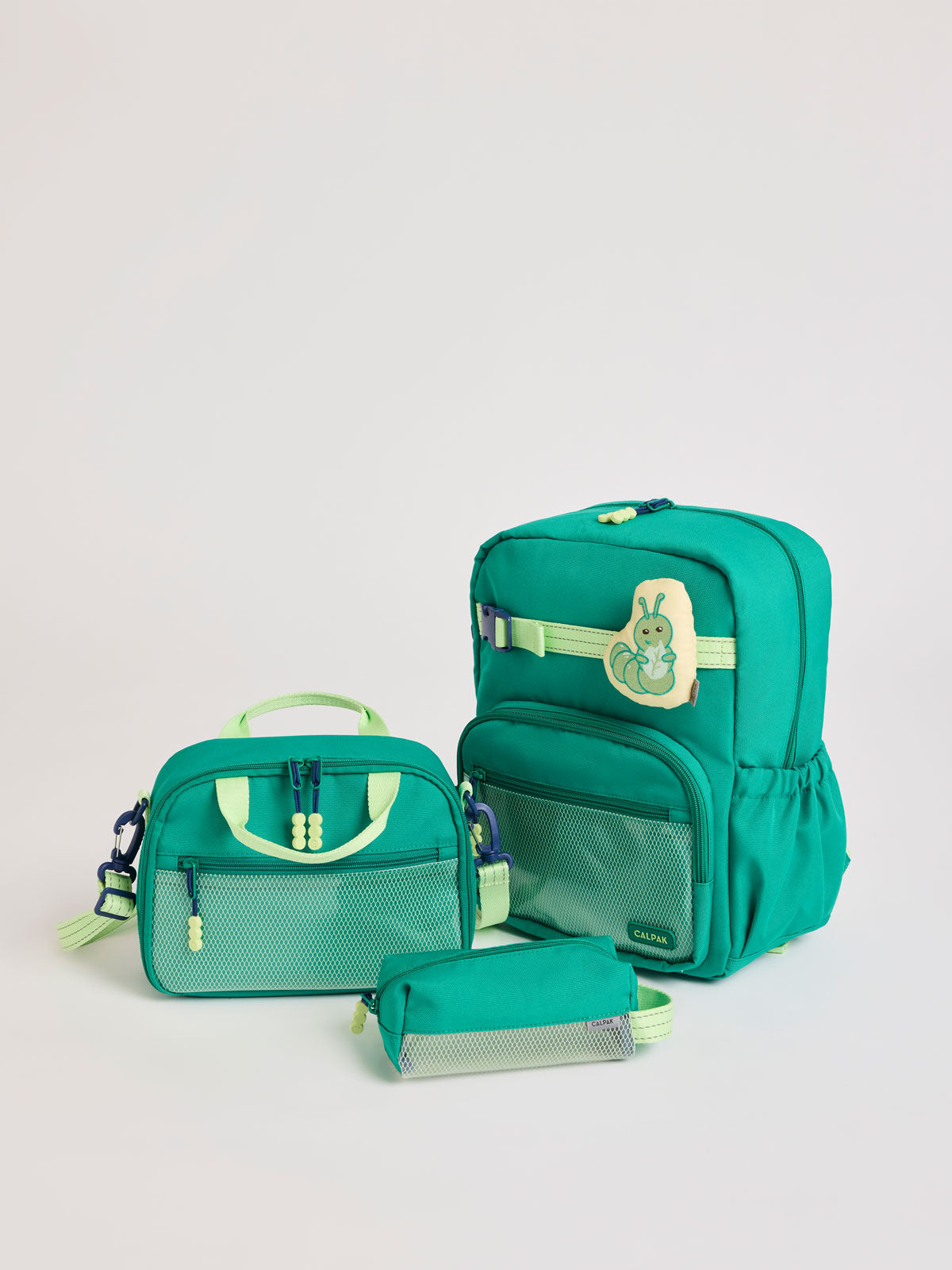Green CALPAK Kids Small Essentials Bundle that includes backpack and lunch bag, and pencil case light gray background; BCKM5000-GREEN