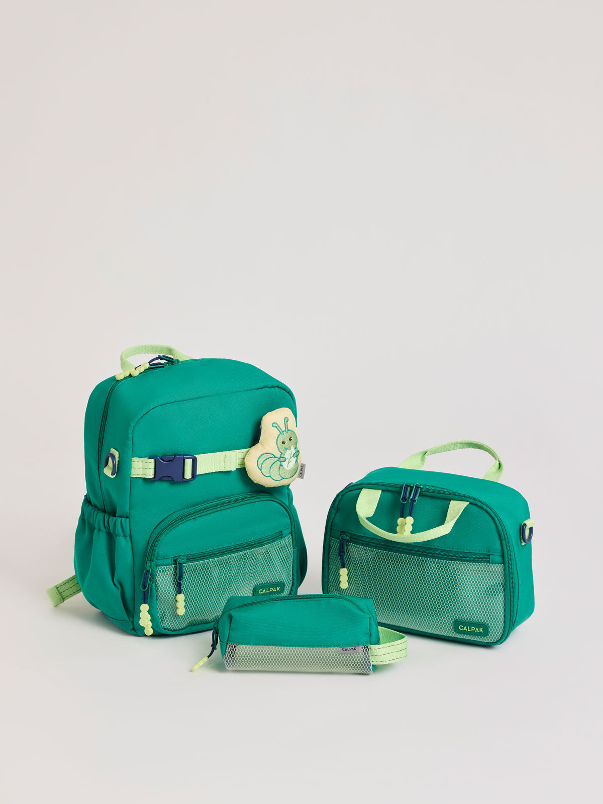 Green CALPAK Kids Small Essentials Bundle that includes backpack and lunch bag, and pencil case light gray background; BCKS5000-GREEN
