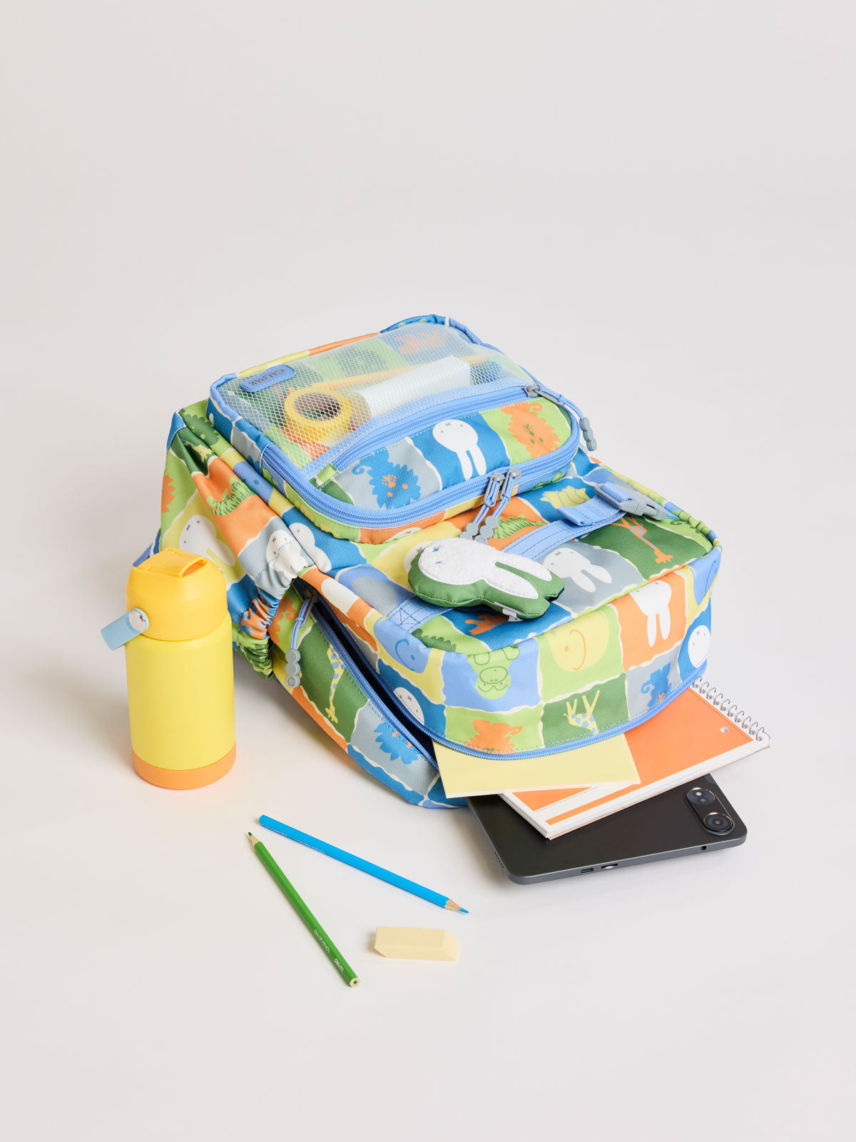 Stationary and CALPAK Kids Medium Backpack with Miffy and blue colorful animal pattern on a white background; CKBM2501-MIFFY-BLUE-ZOO-TRIP