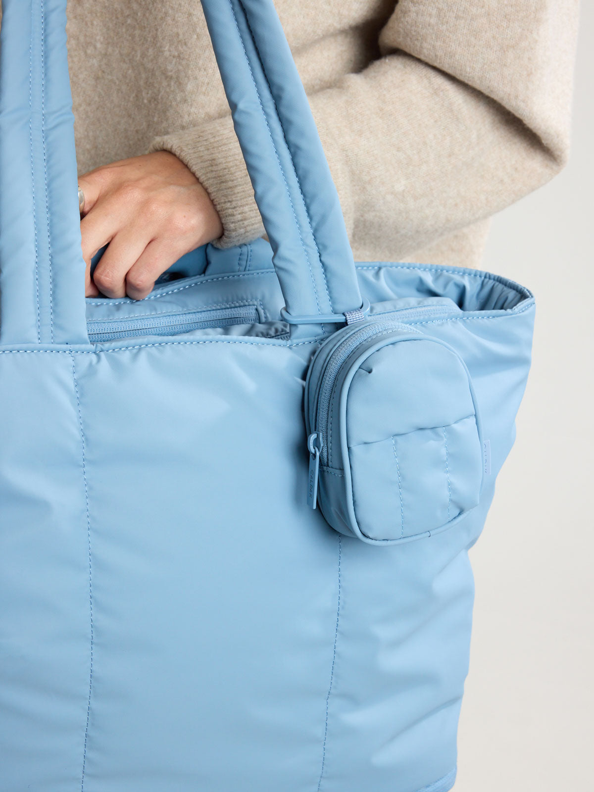 CALPAK Luka Backpack Zip Bag Charm in light blue French Blue clipped on bag ; AMB2201-FRENCH-BLUE
