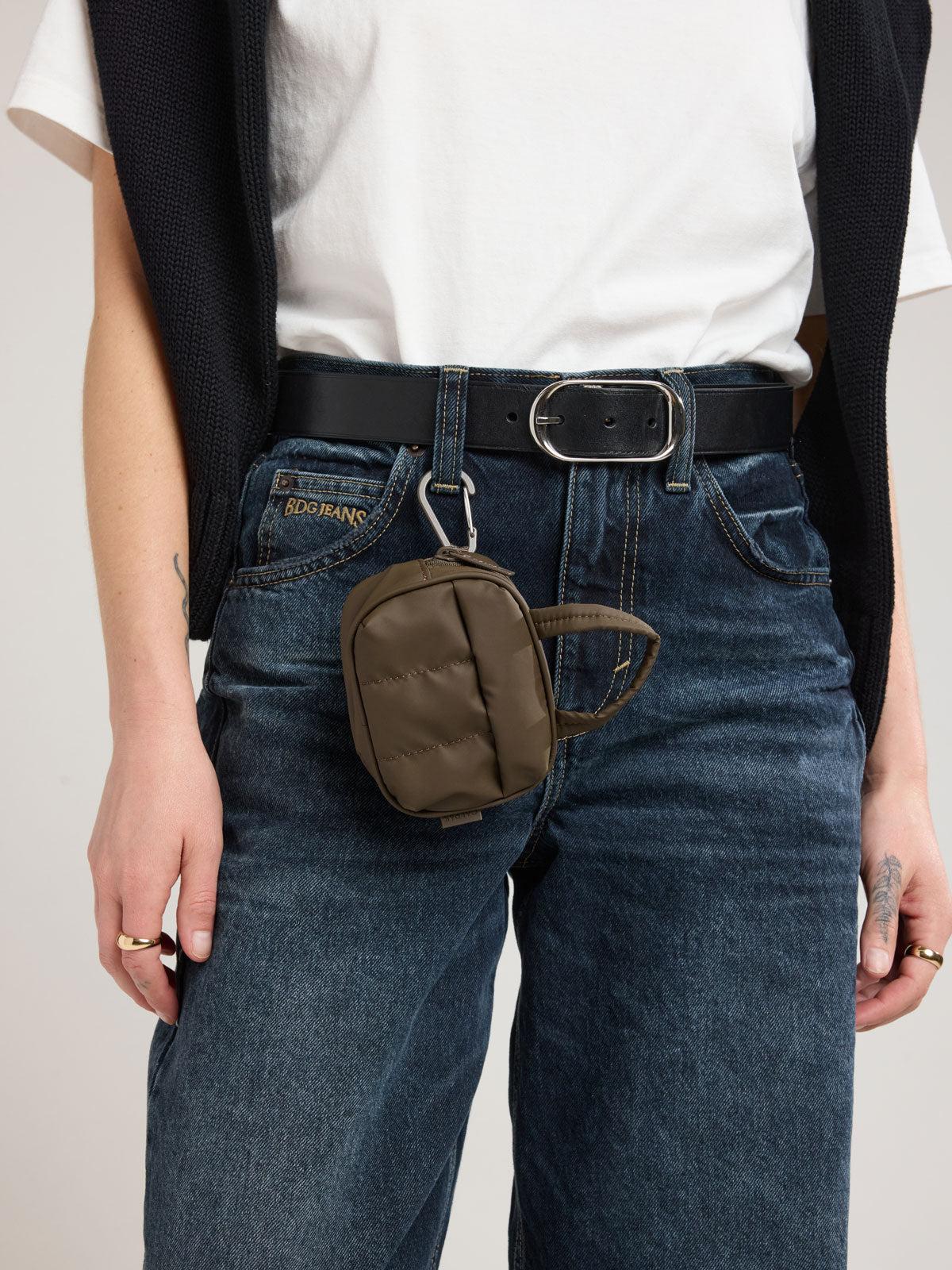 Person with clipped CALPAK Luka Duffel Zip Bag Charm in brown Mushroom; ALK2501-MUSHROOM