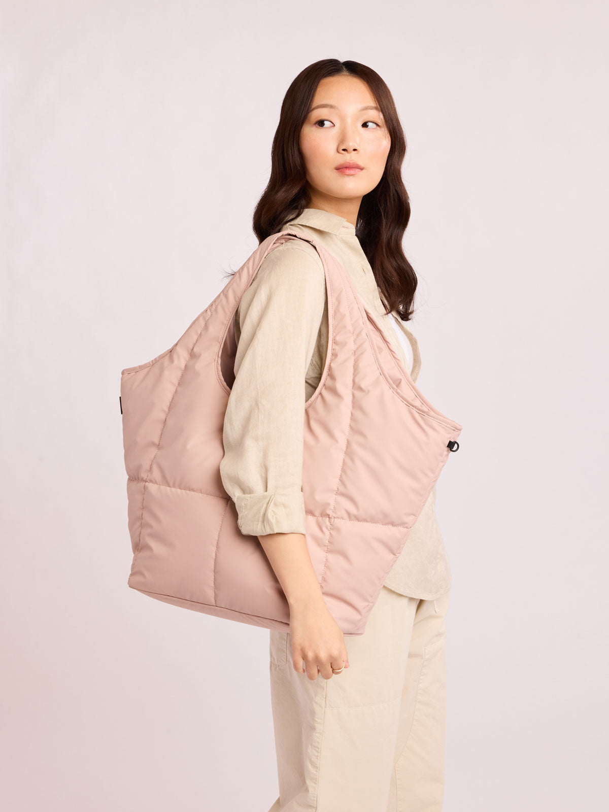 Woman with CALPAK Luka Everything Tote in light pink Rose Quartz; AET2601-ROSE-QUARTZ