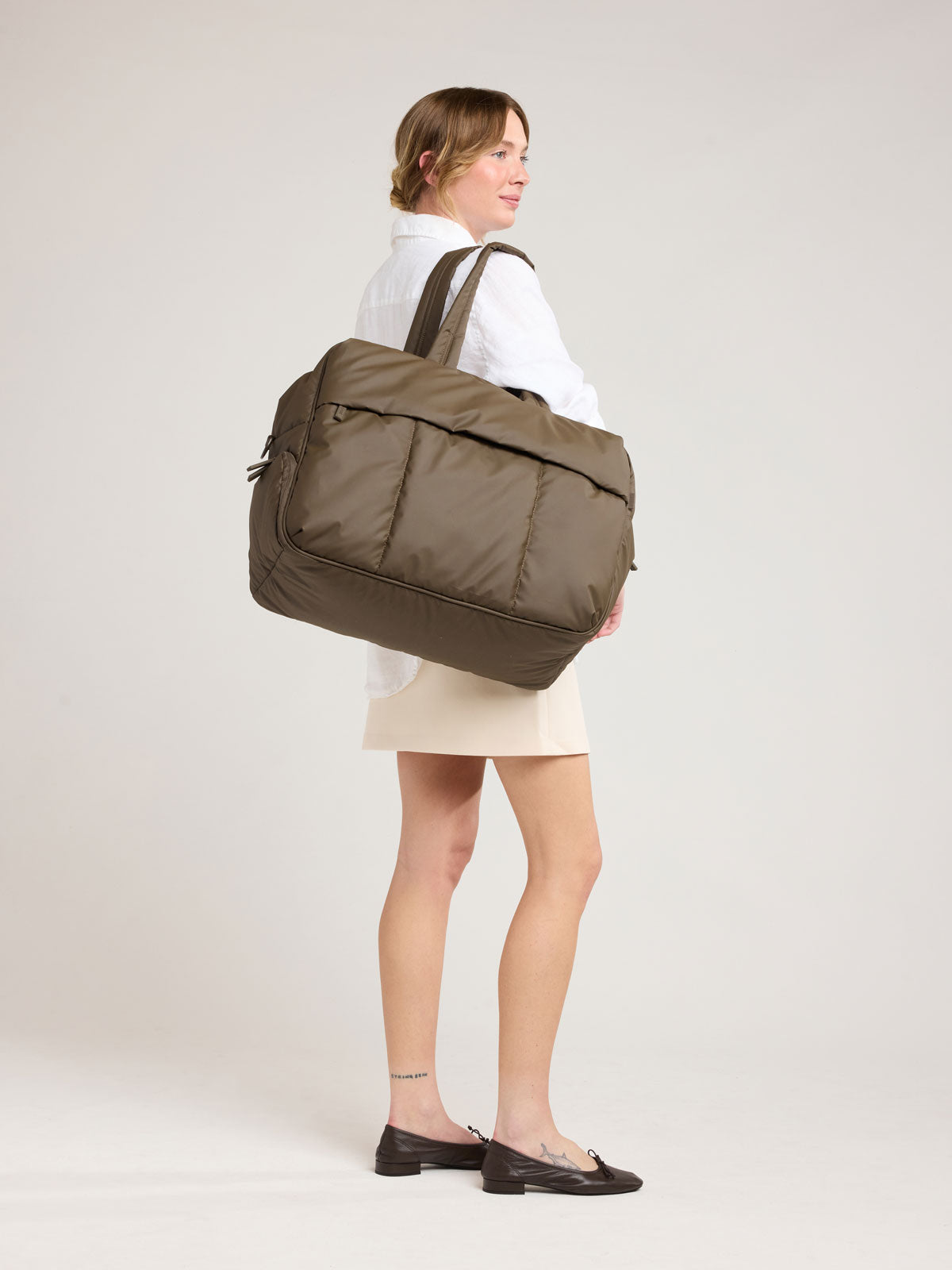 Woman with CALPAK Luka Large Duffel in brown Mushroom; DLL2201-MUSHROOM