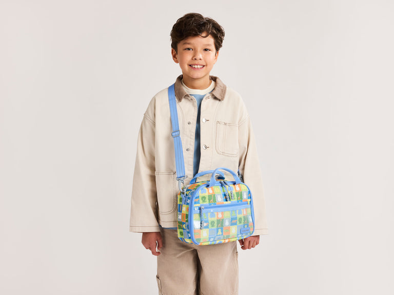 Child model wearing blue CALPAK Miffy Insulated Lunch Bag 